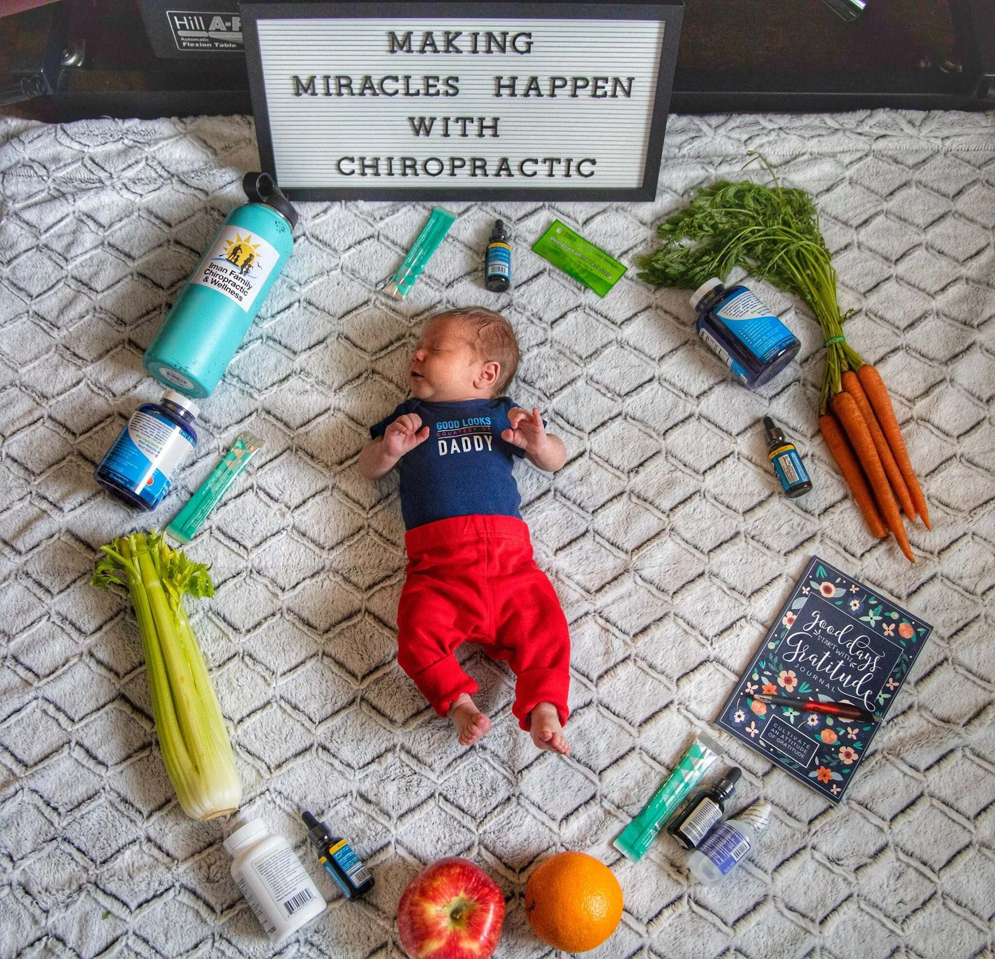 Baby surrounded by vitamins and health food.