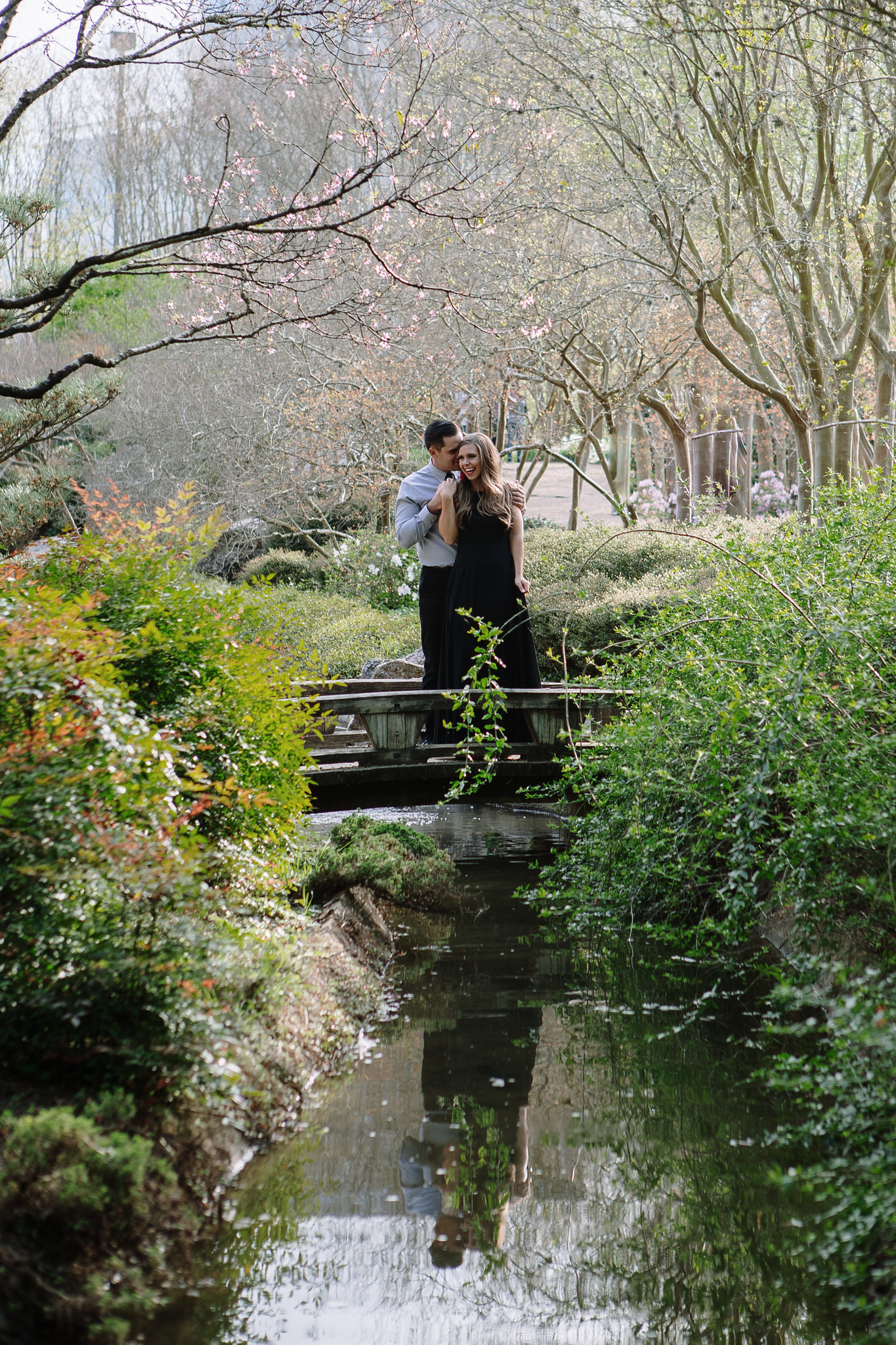 Couple on a bridge Engagement Photo Session at Hermann Park Houston, TX