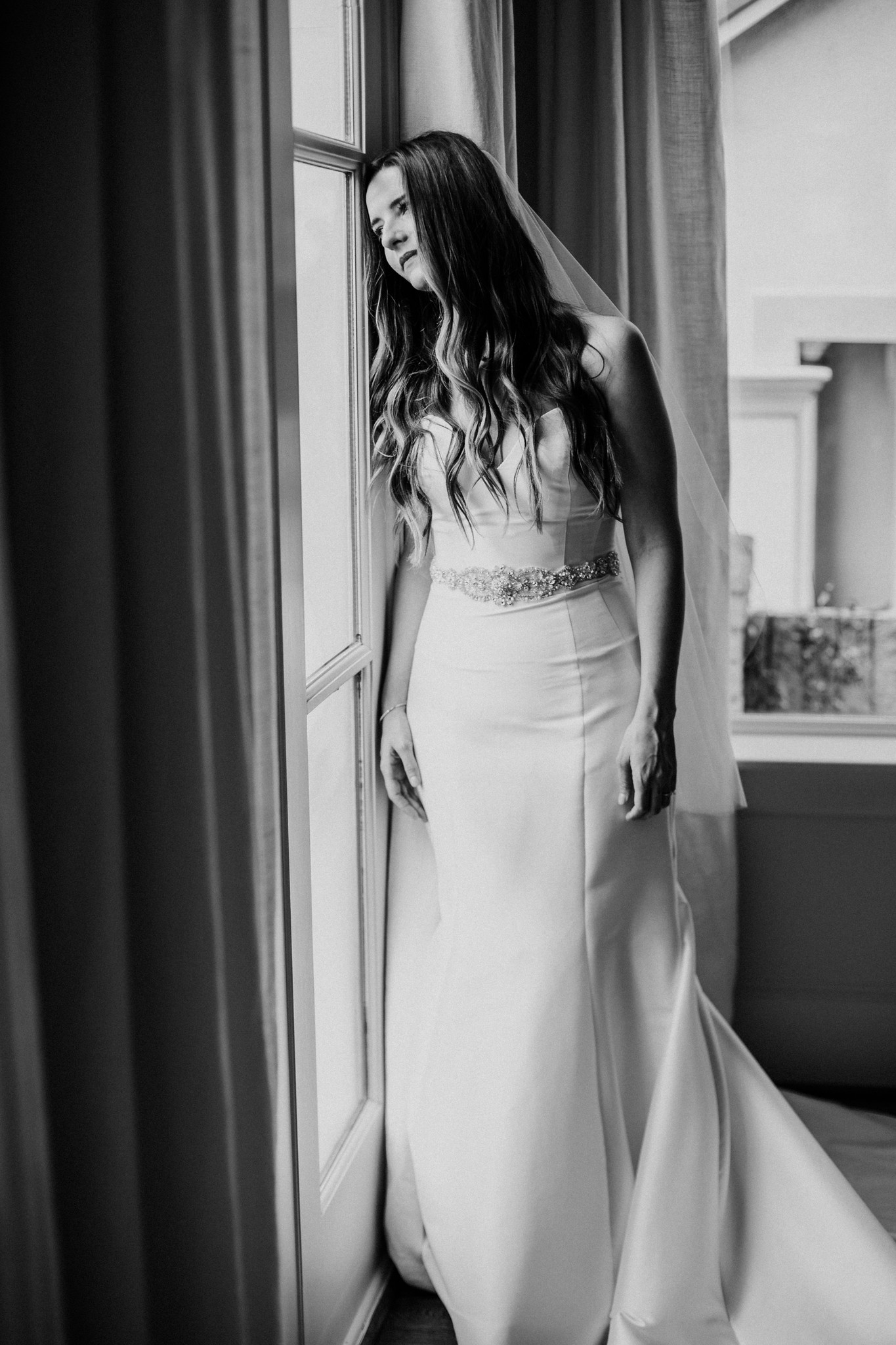 Bride by the window looking outside. Bridal Photo Session at Private House West U Houston, TX