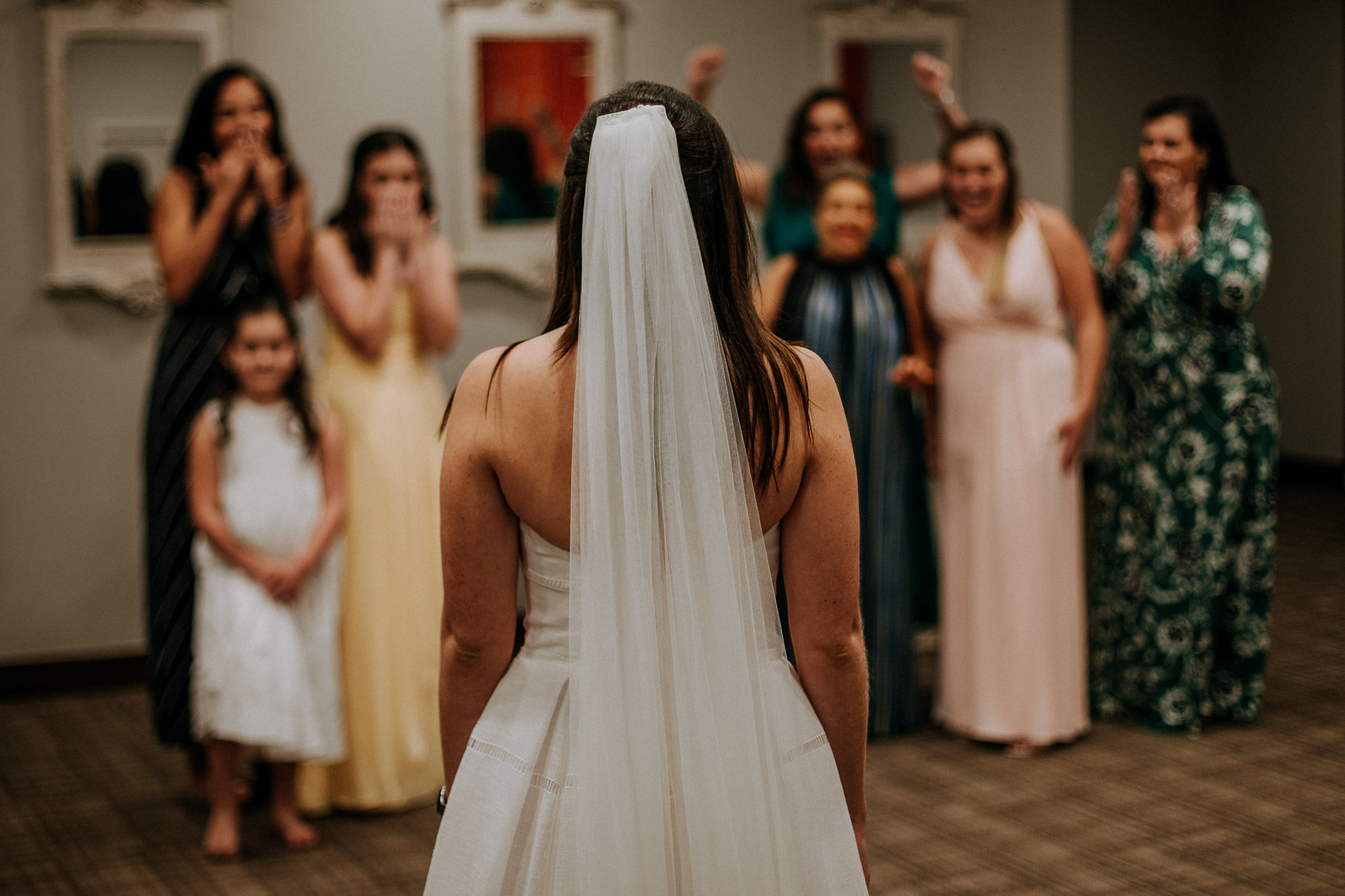 Bride first look with bridesmaids. Wedding at Cotton Gin No 116 Katy, TX