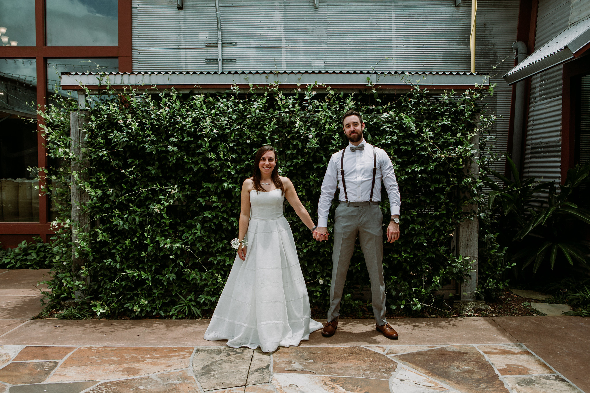 Bride and groom holding hands. Wedding at Cotton Gin No 116 Katy, TX