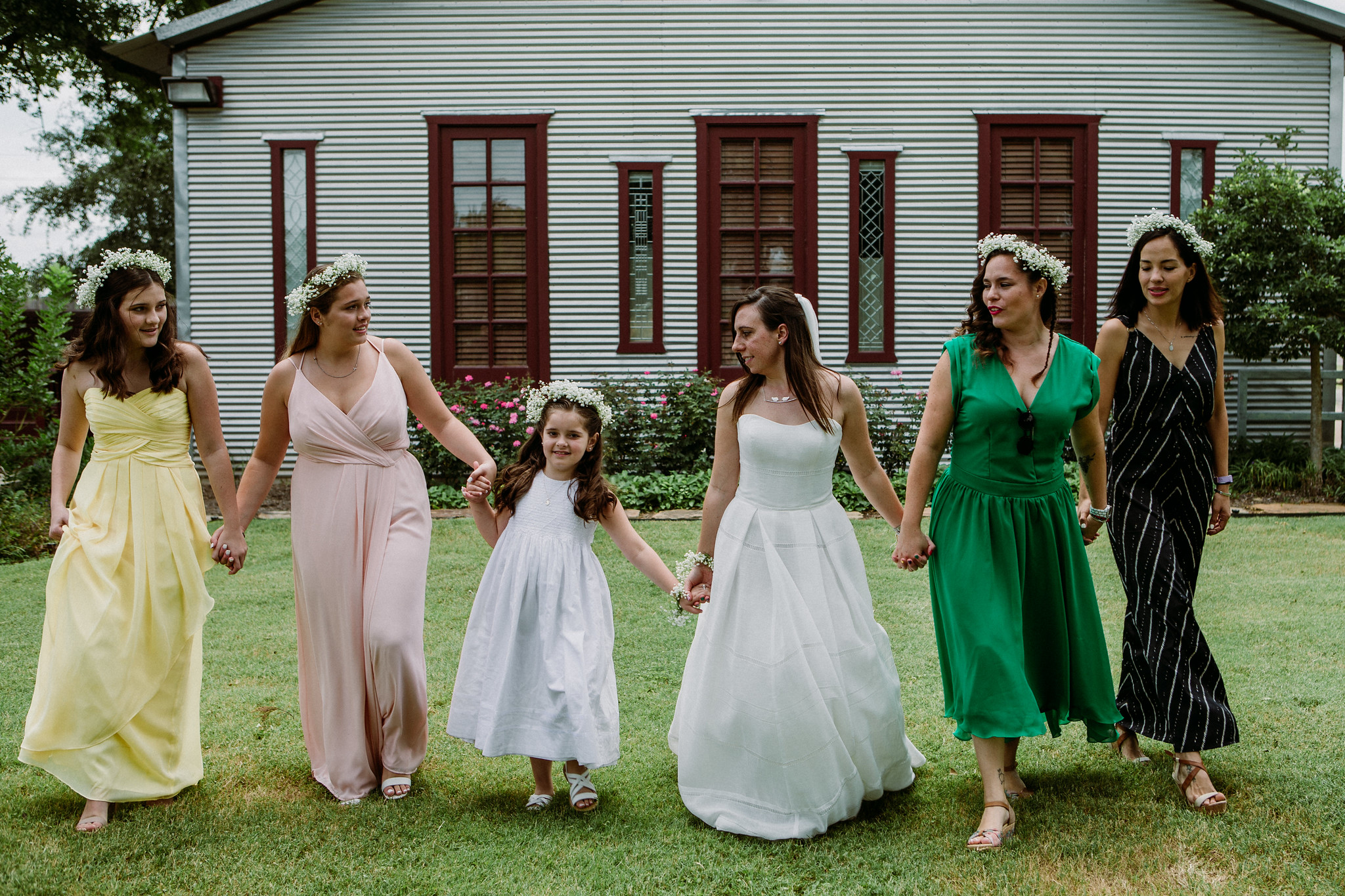 Bride walking with bridesmaids. Wedding at Cotton Gin No 116 Katy, TX