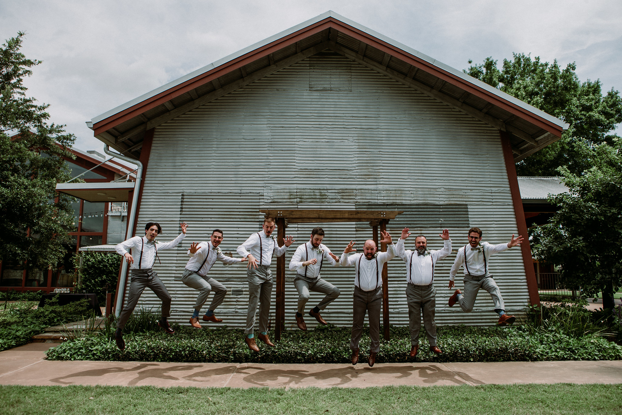 Groom and groomsmen jumping. Wedding at Cotton Gin No 116 Katy, TX