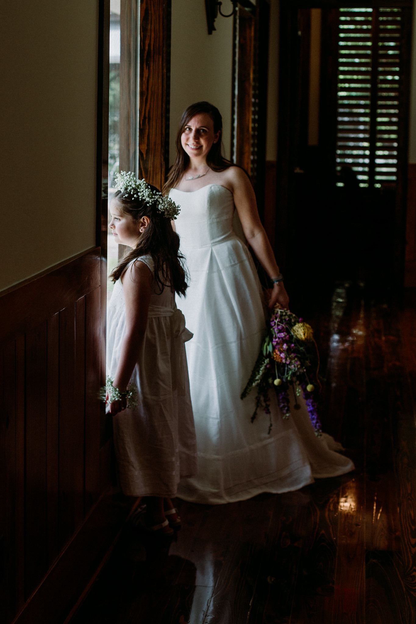 Bride and flower girl by the window. Wedding at Cotton Gin No 116 Katy, TX