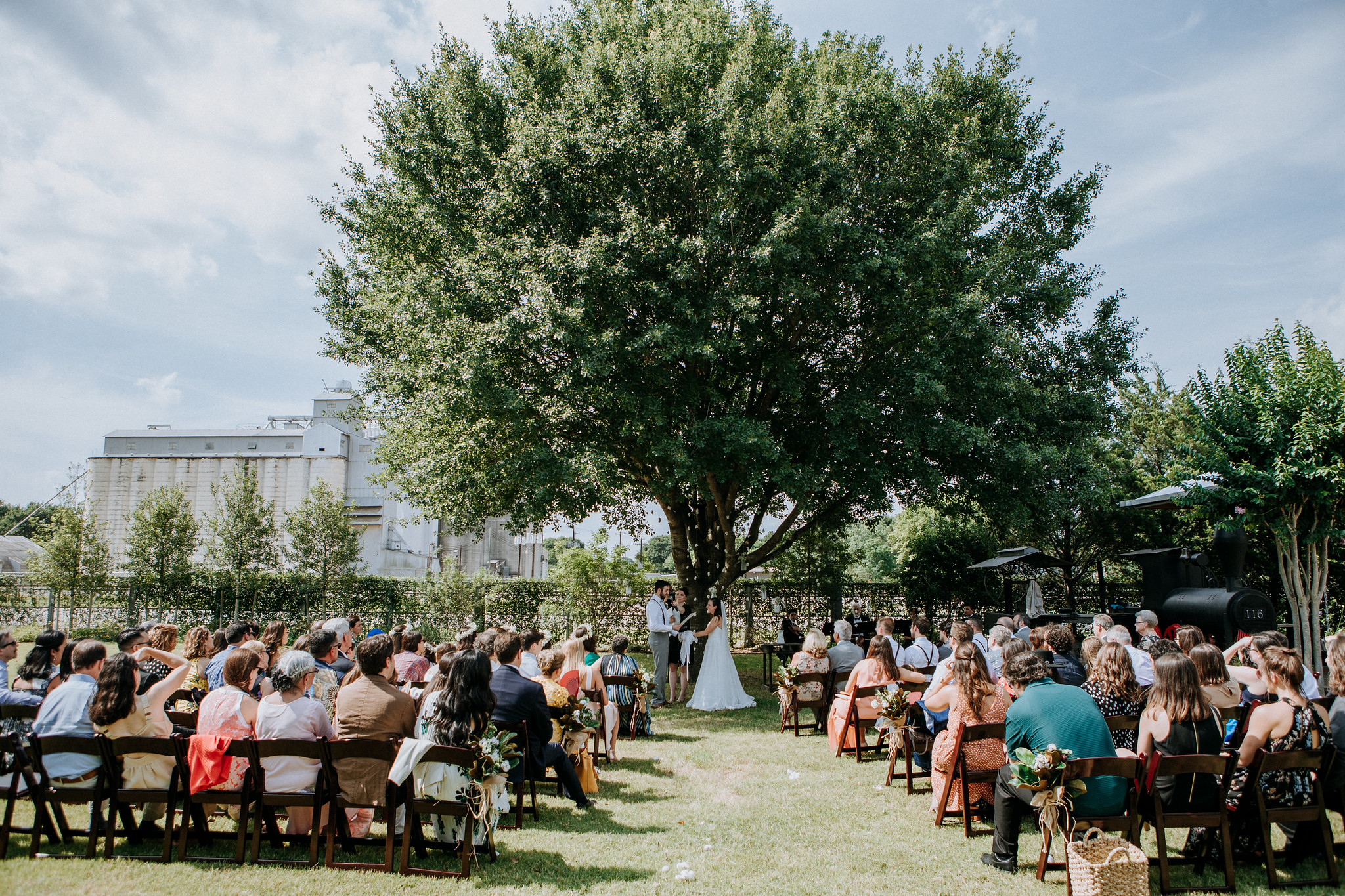 Outdoor Ceremony under the tree. Wedding at Cotton Gin No 116 Katy, TX