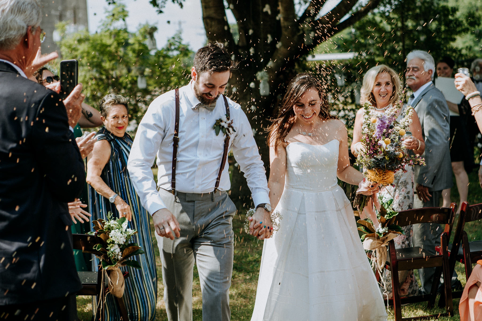 Bride and groom walking down the aisle. Golden seeds send off. Wedding at Cotton Gin No 116 Katy, TX