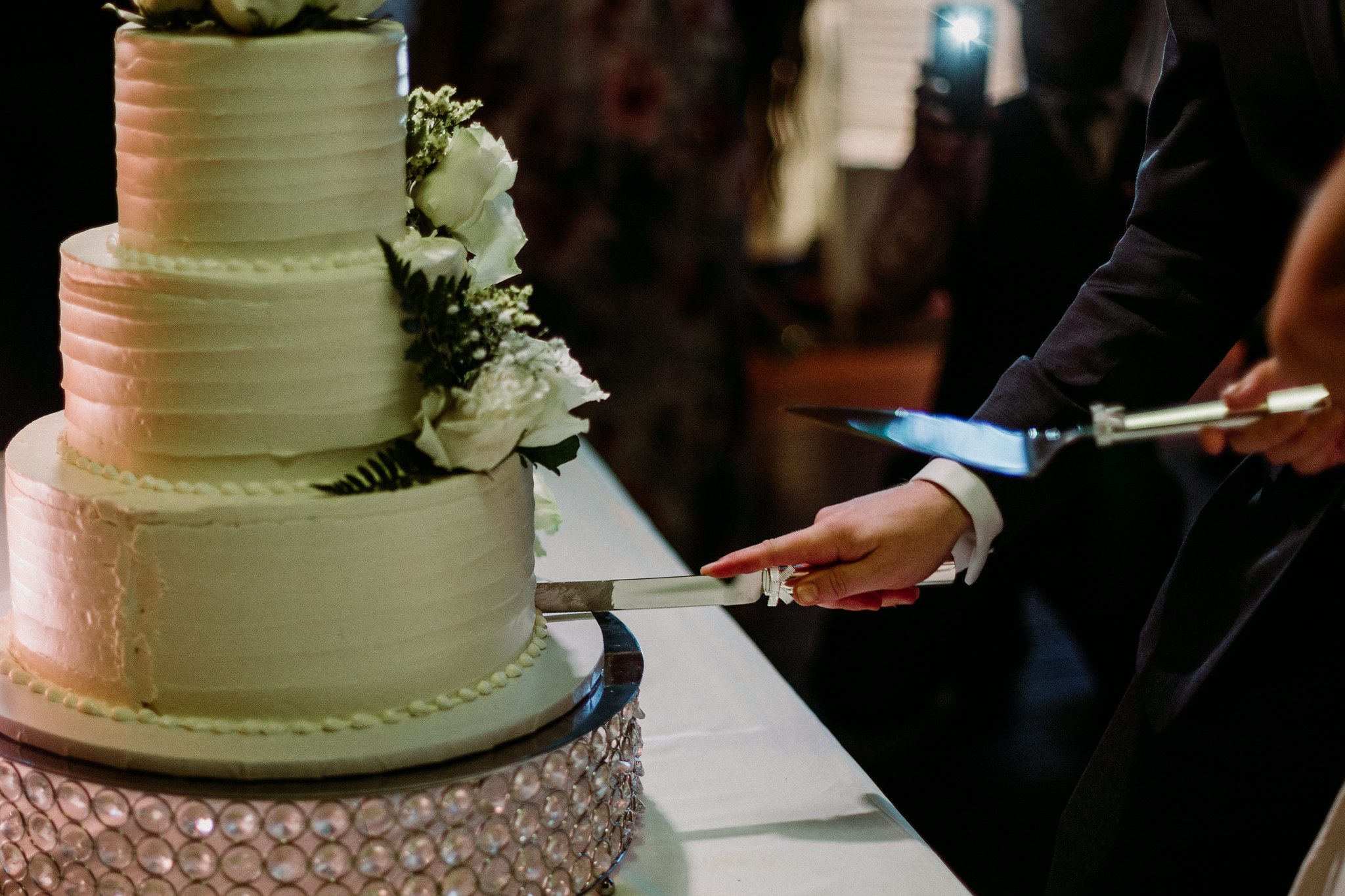 Bride and groom cake cutting. Reception. Wedding at The Grove at Discovery Green Park (Houston, TX)