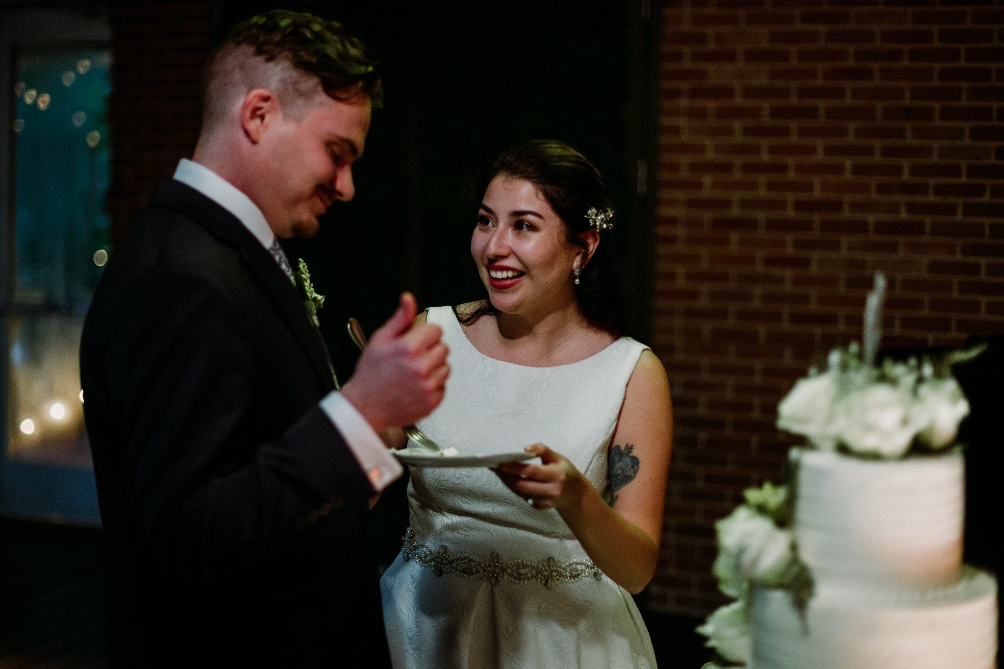 Bride and groom cake cutting. Reception. Wedding at The Grove at Discovery Green Park (Houston, TX)