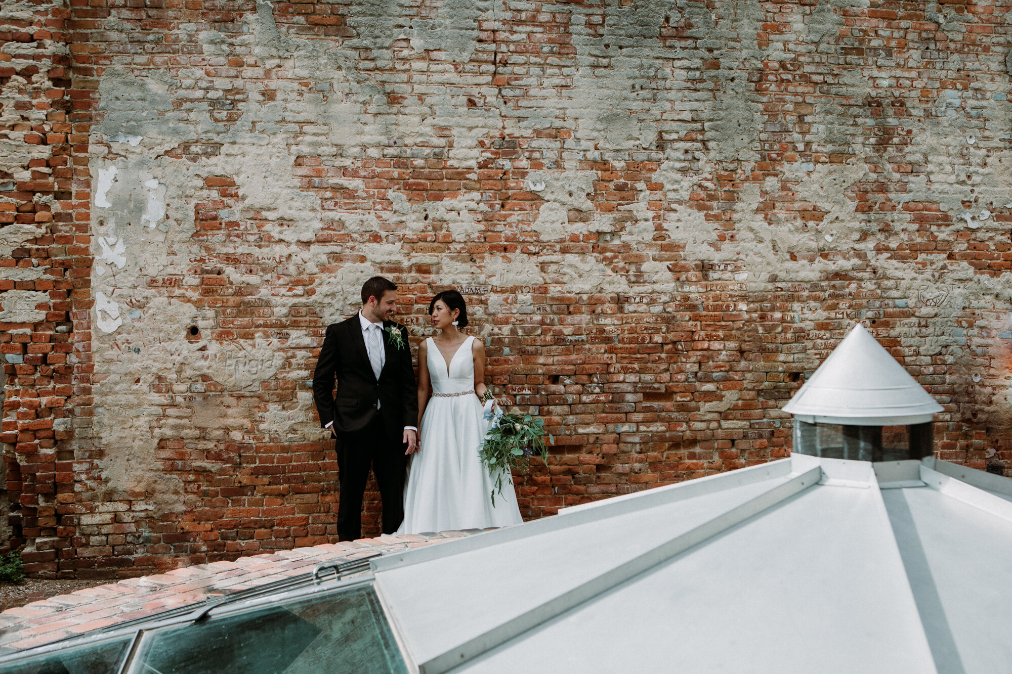 Captivating Micro Wedding Bride and Groom Couples Portraits brick wall Downtown Brenham, TX