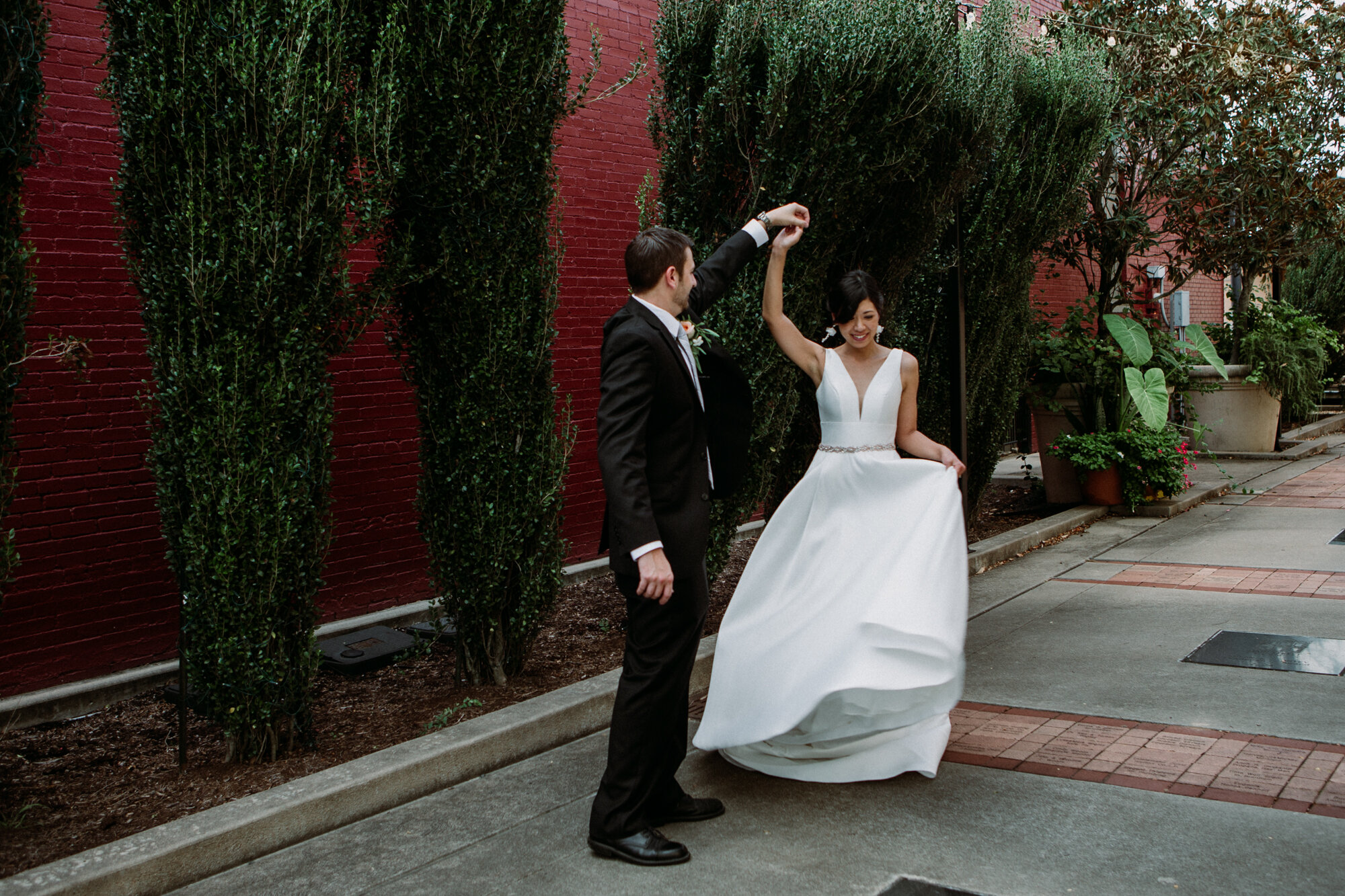 Captivating Micro Wedding Bride and Groom Couples Portraits red wall Downtown Brenham, TX