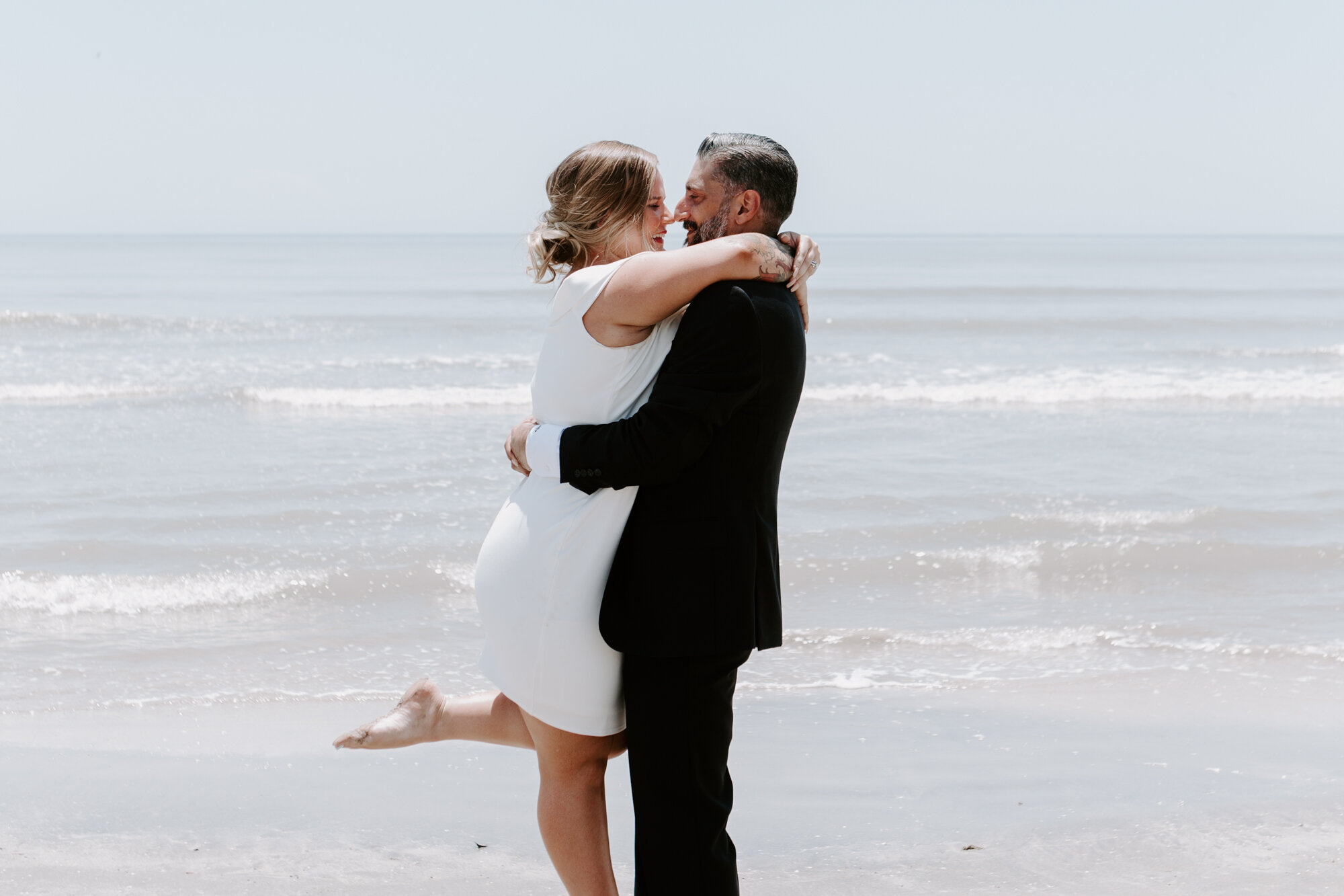 Bride and groom lift and spin portraits. Micro Wedding (Elopement) on the Beach