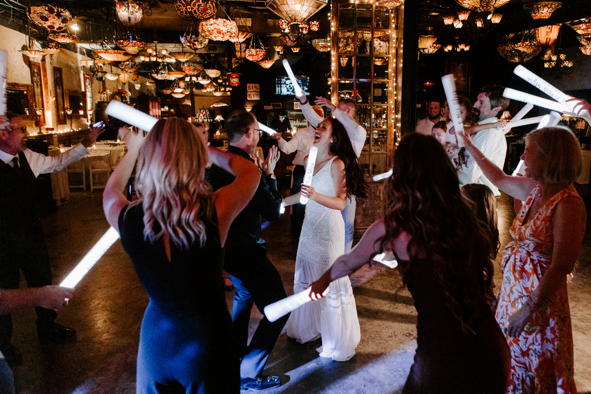 Party dancing with glow sticks. Glamorous Wedding Reception at Nouveau Antique Art Venue