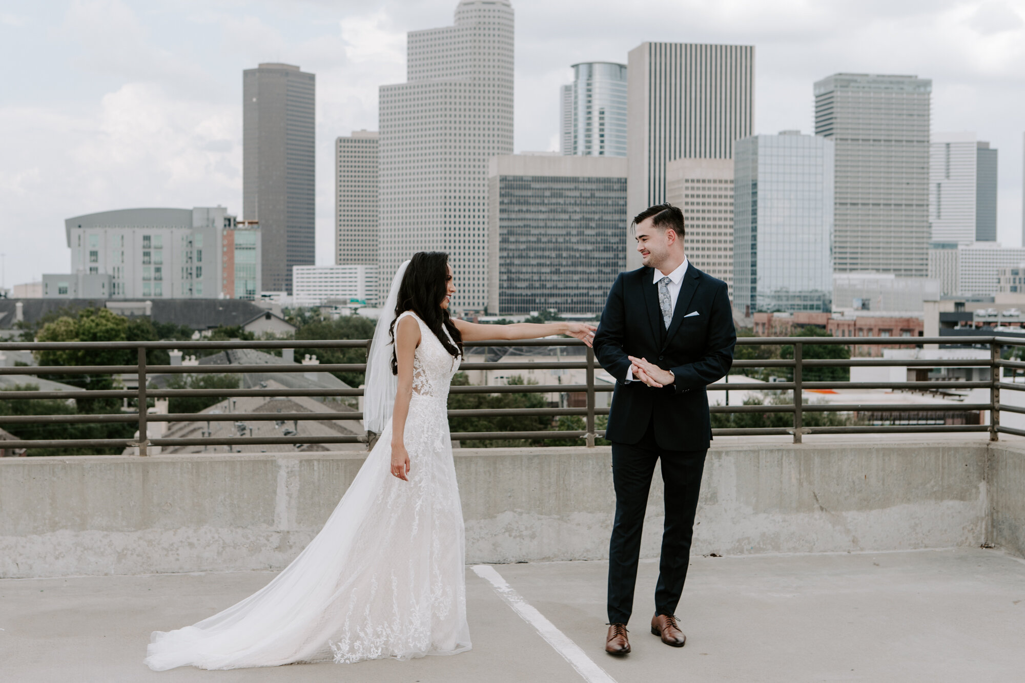 Vivacious Wedding bride and groom first look in Midtown with downtown skyline view