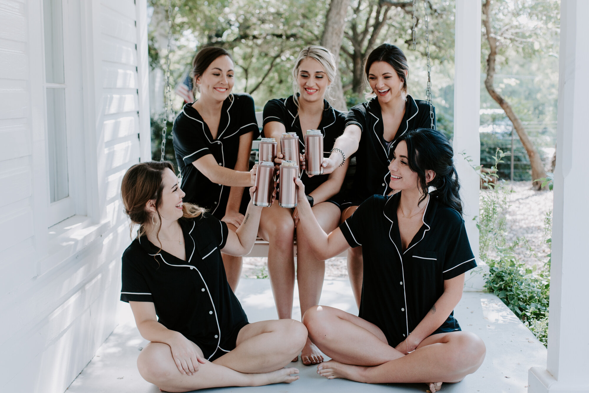 Bride getting ready portraits with bridesmaids wearing pjs. Radiant Bohemian Hill Country Wedding at Gruene Estate in New Braunfels, TX