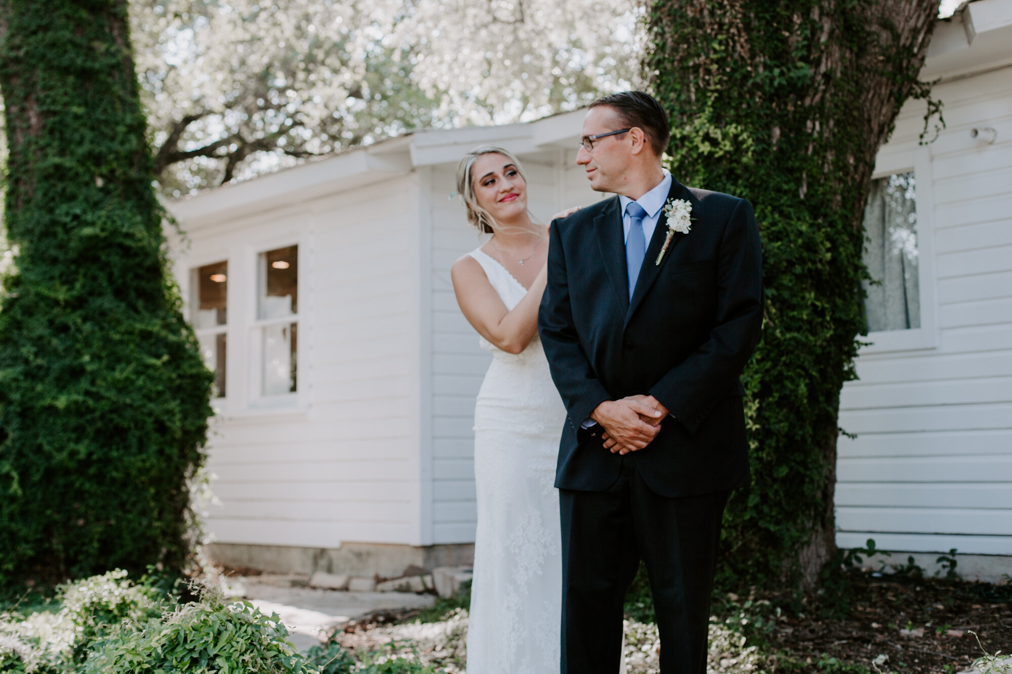 Bride first look with dad. Radiant Bohemian Hill Country Wedding at Gruene Estate in New Braunfels, TX