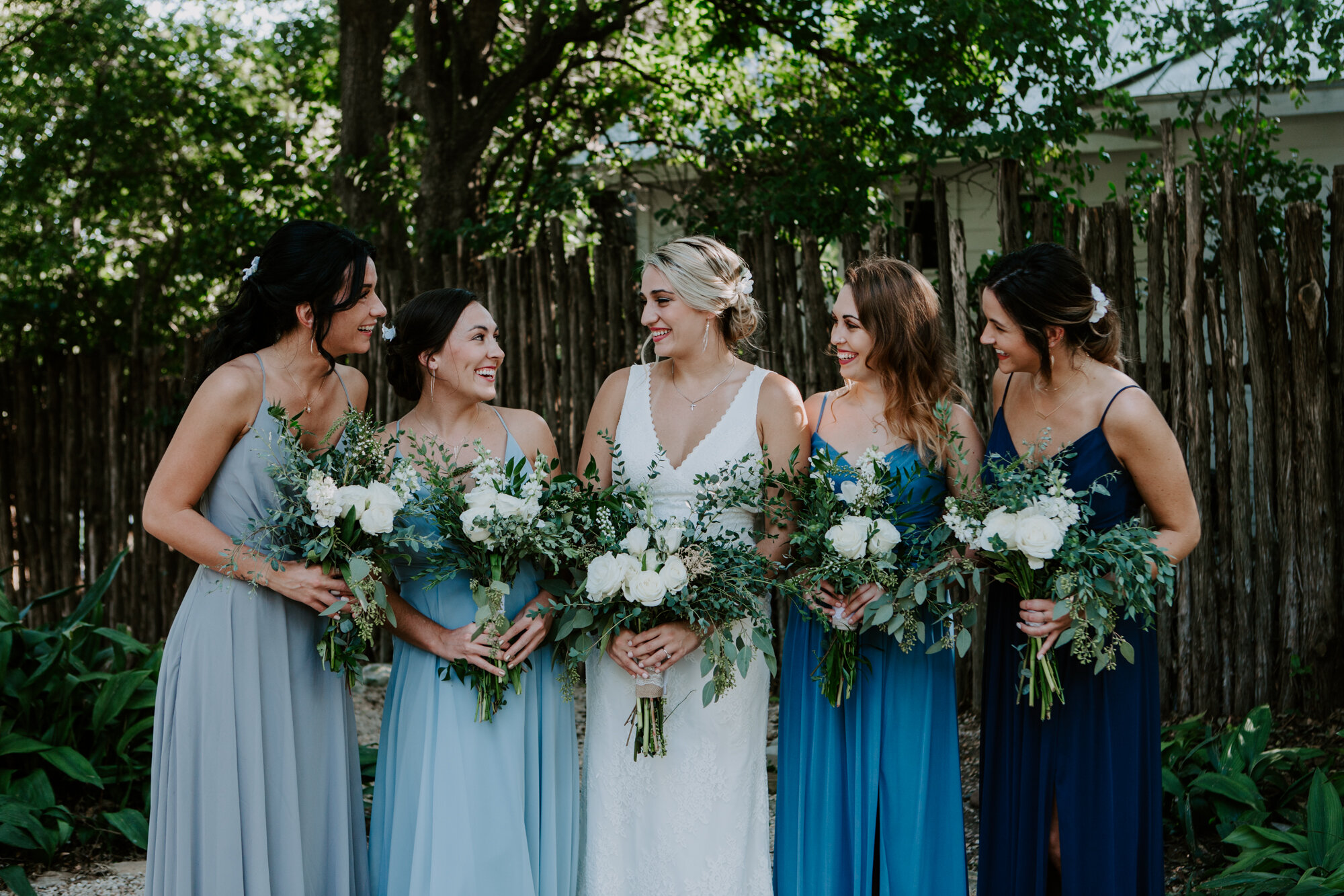Bride with bridesmaids portraits. Radiant Bohemian Hill Country Wedding at Gruene Estate in New Braunfels, TX