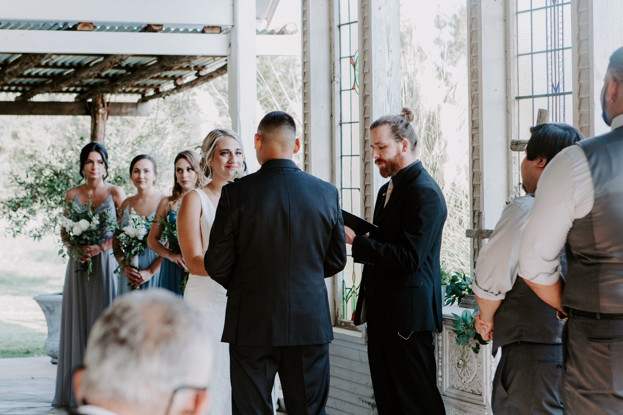 Bride looking at groom. Ceremony. Radiant Bohemian Hill Country Wedding at Gruene Estate in New Braunfels, TX