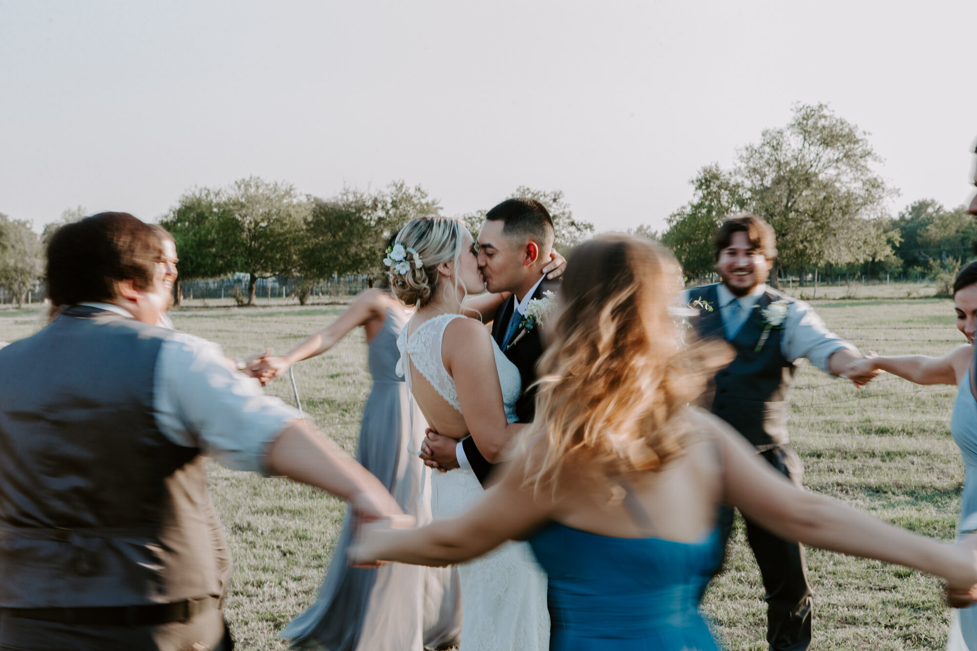 Bride and groom with bridal party merry-go-round portraits. Radiant Bohemian Hill Country Wedding at Gruene Estate in New Braunfels, TX