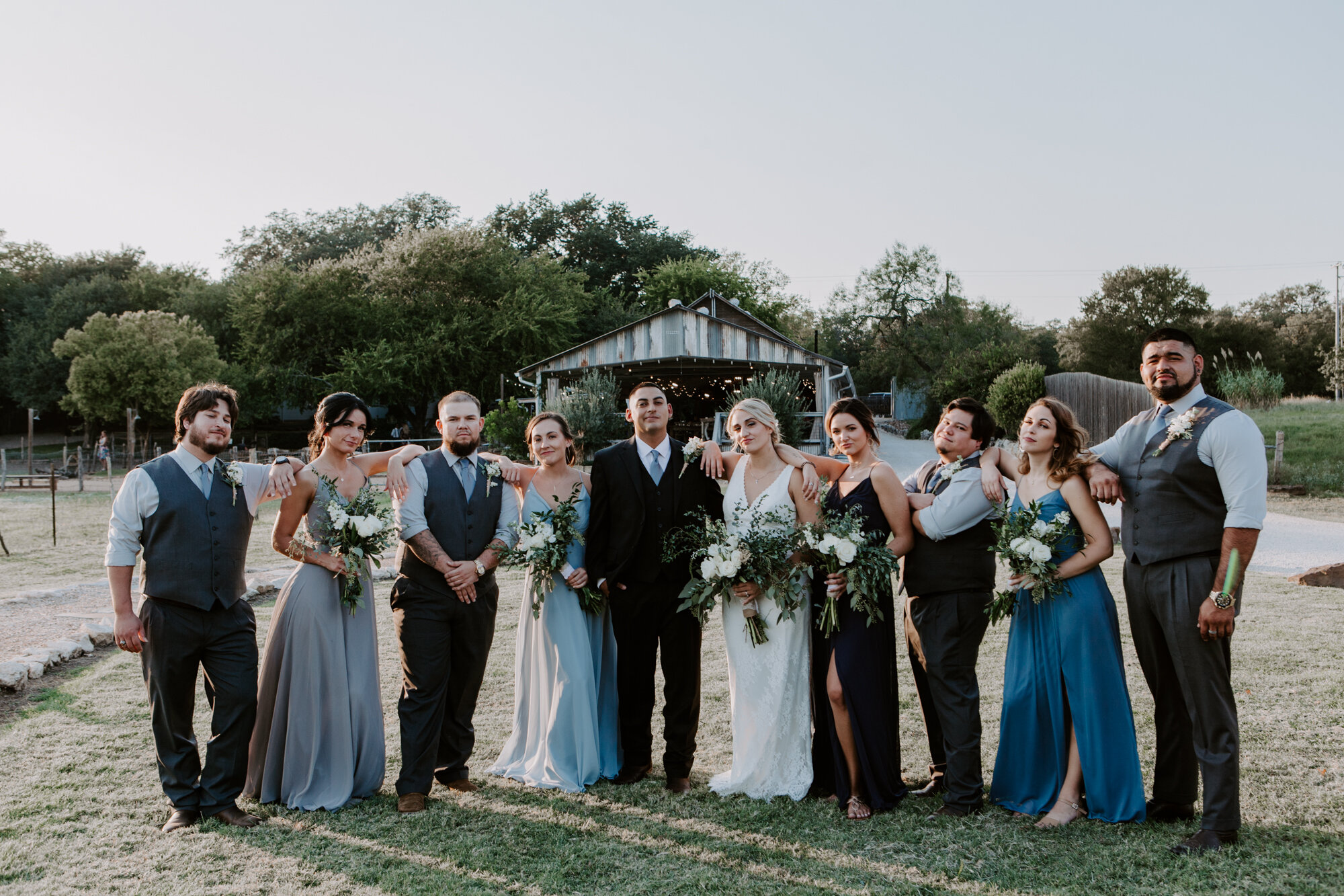 Bride and groom with bridal party cool sassy poses. Radiant Bohemian Hill Country Wedding at Gruene Estate in New Braunfels, TX