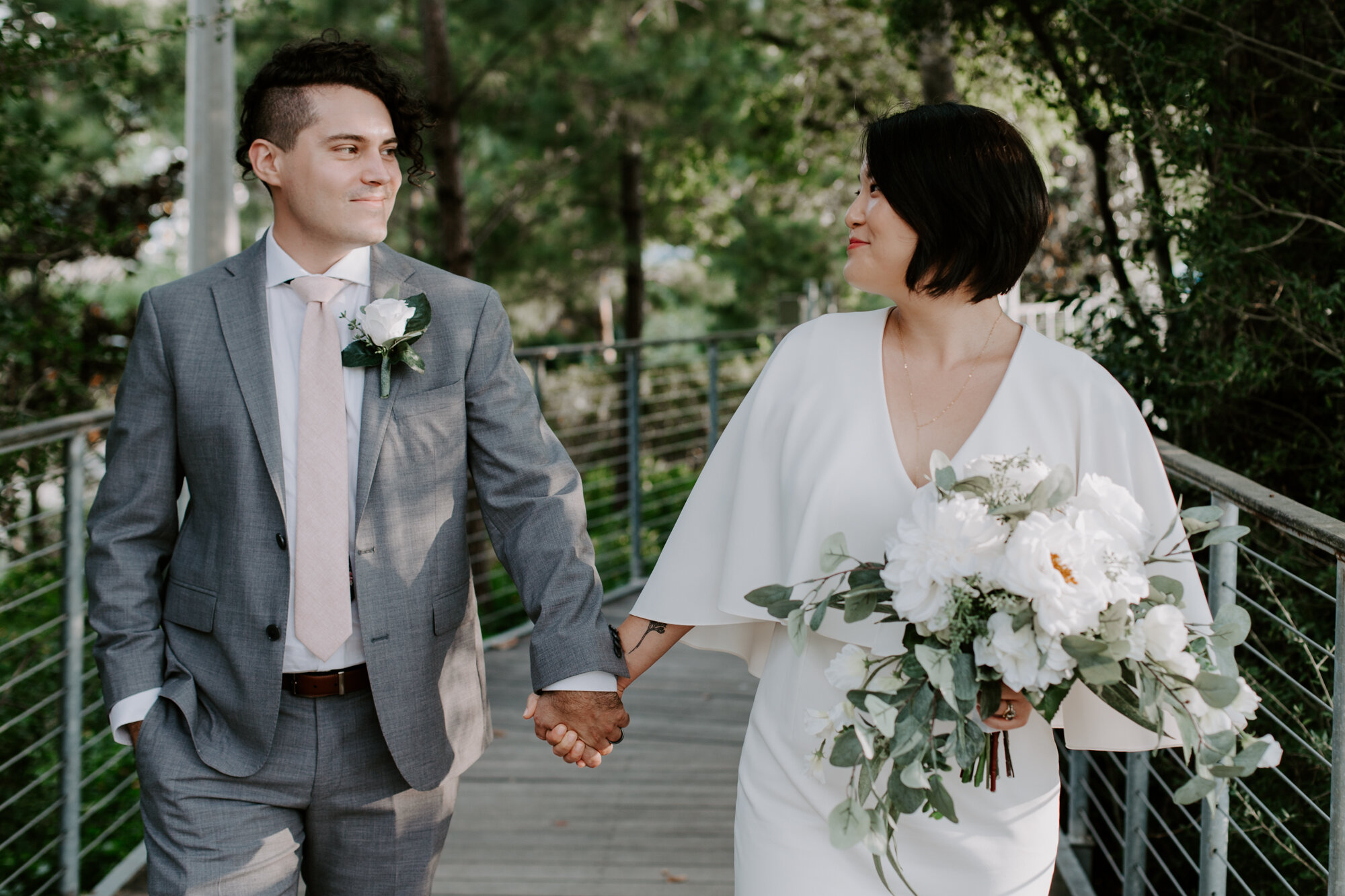 Walking holding hands. Bride and Groom Wedding Photo Session at The Lost Lake Buffalo Bayou Park