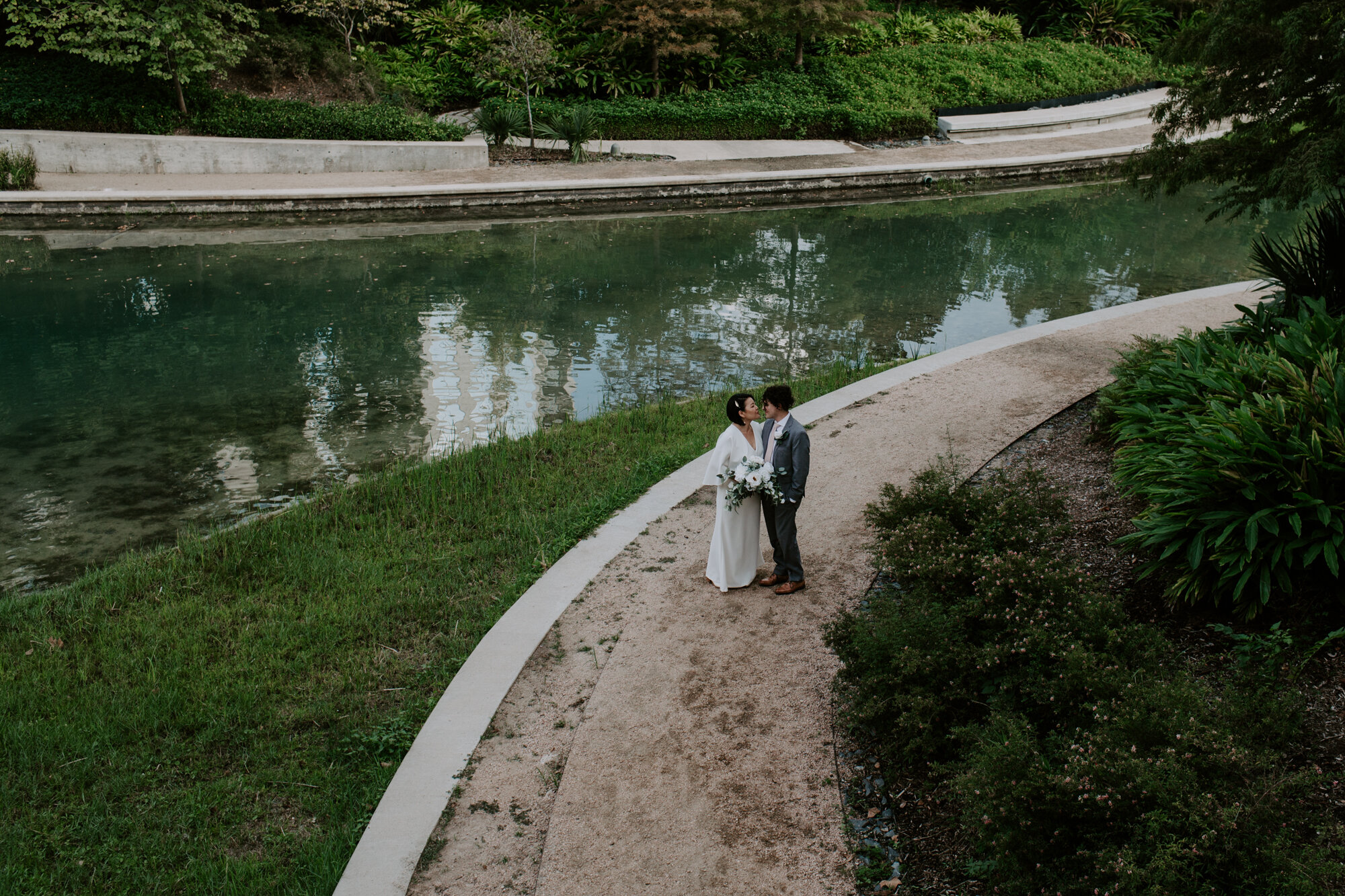 Kissing on the road. Bride and Groom Wedding Photo Session at The Lost Lake Buffalo Bayou Park