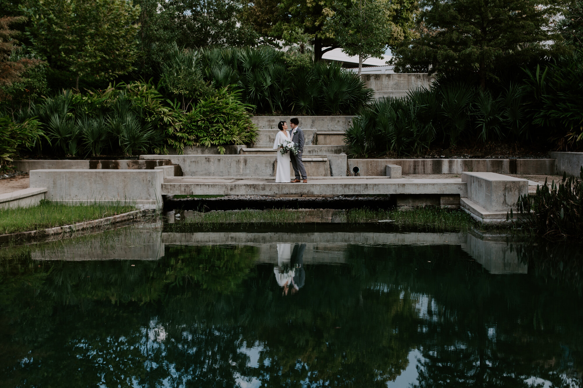 Reflections in the pool. Bride and Groom Wedding Photo Session at The Lost Lake Buffalo Bayou Park