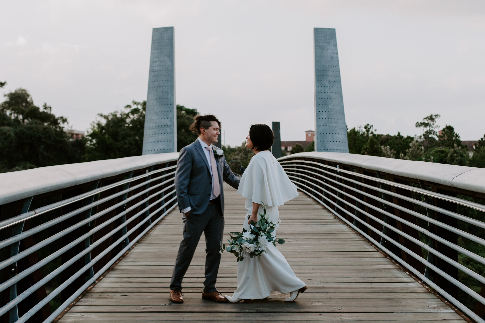 Dancing on a bridge. Bride and Groom Wedding Photo Session at The Lost Lake Buffalo Bayou Park