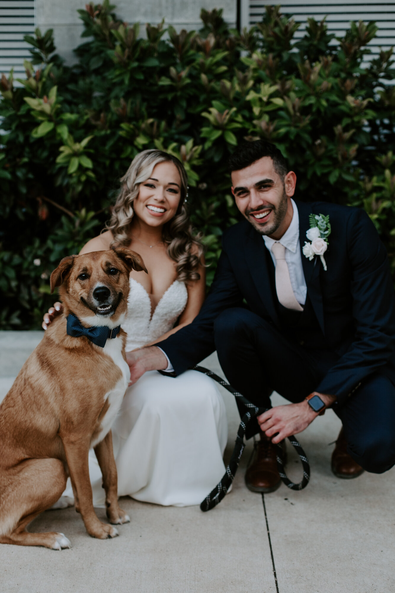 Bride and groom portrait with smiling dog. Glamorous Wedding at The Dunlavy and the Lost Lake Buffalo Bayou Park