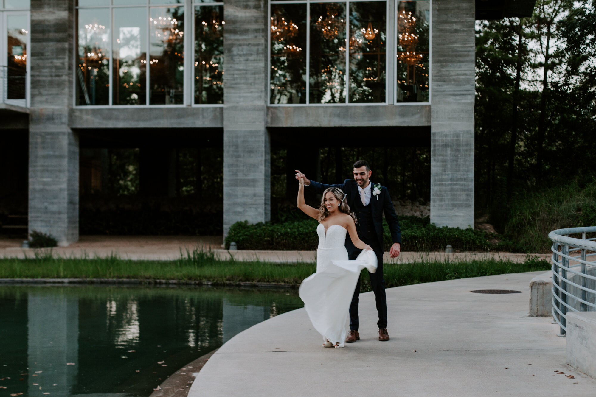 Bride and groom dance in front of the venue. Glamorous Wedding at The Dunlavy and the Lost Lake Buffalo Bayou Park