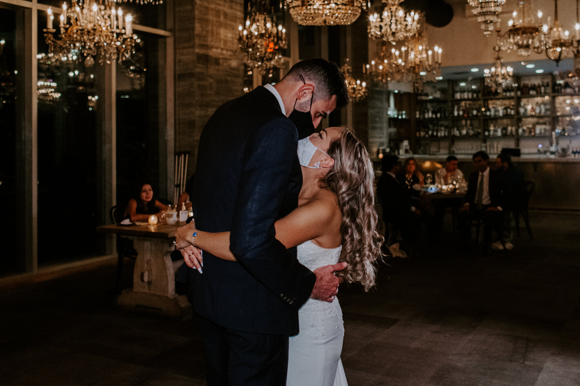 Bride and groom dancing kissing with masks on COVID-19 quarantine. Glamorous Wedding at The Dunlavy and the Lost Lake Buffalo Bayou Park