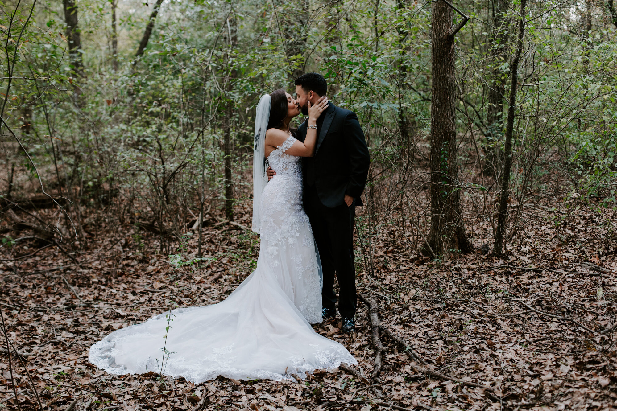 Kissing in the forest. Trash the Dress Bride and Groom Photo Session at Houston Arboretum and Nature Center