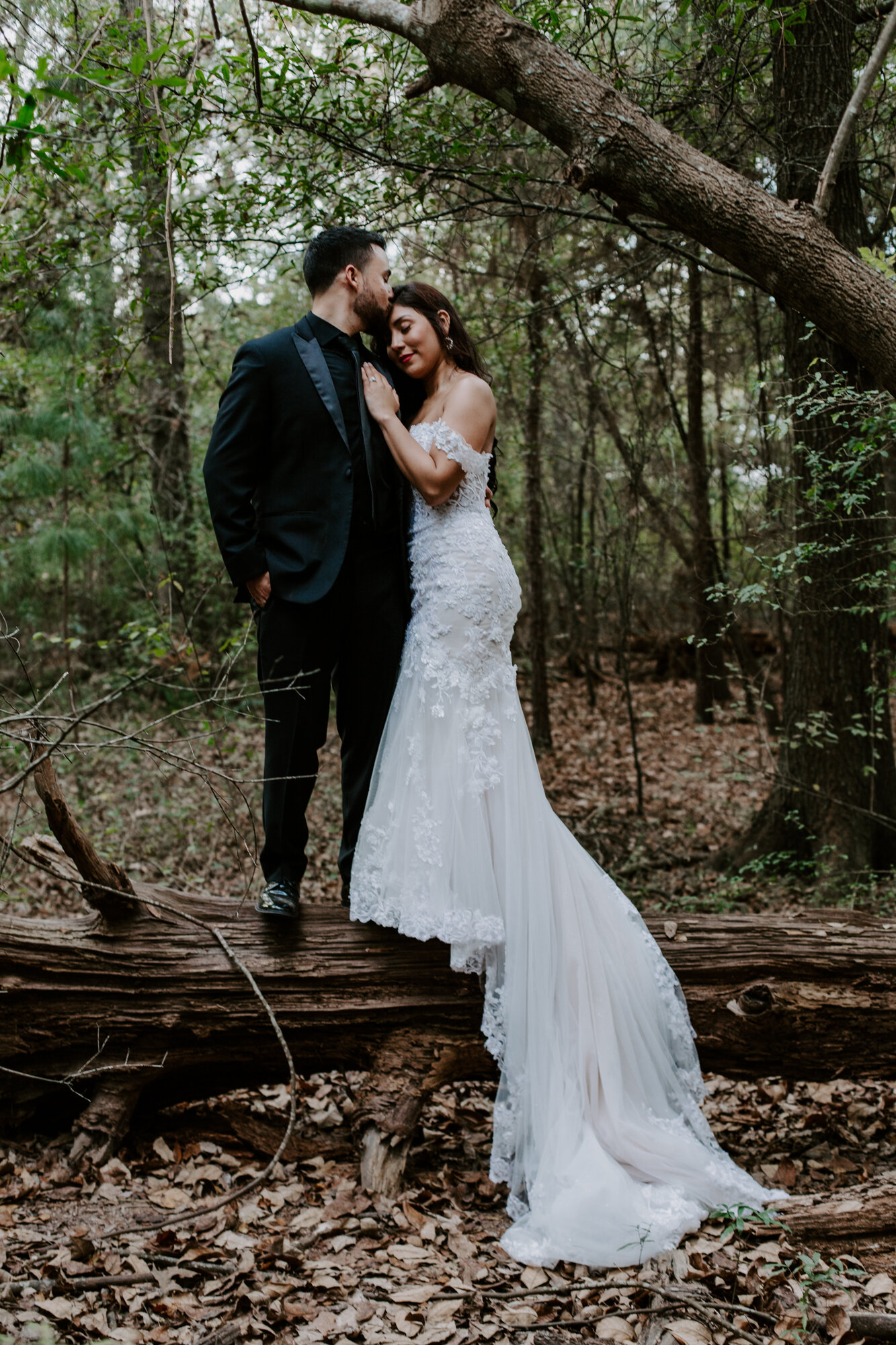 Balancing on a fallen tree. Trash the Dress Bride and Groom Photo Session at Houston Arboretum and Nature Center