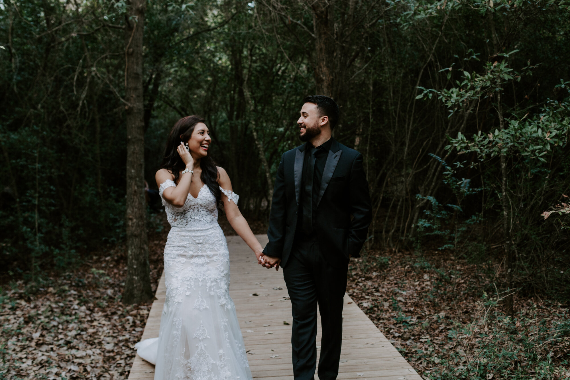 Walking and laughing. Trash the Dress Bride and Groom Photo Session at Houston Arboretum and Nature Center