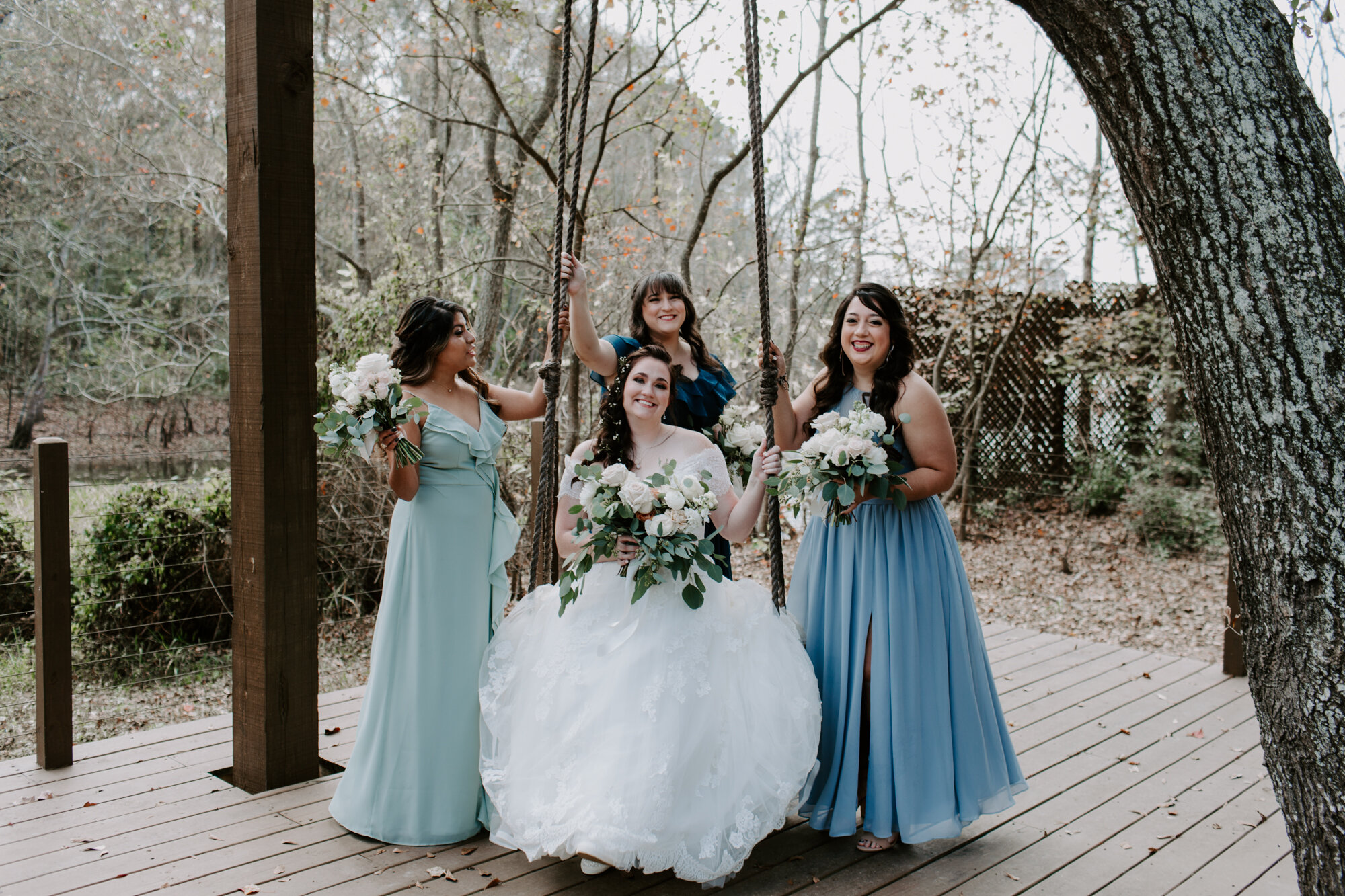 Bride and bridesmaids portraits on a swing. Fairy Romantic Wedding at Magnolia Bells in Magnolia, TX