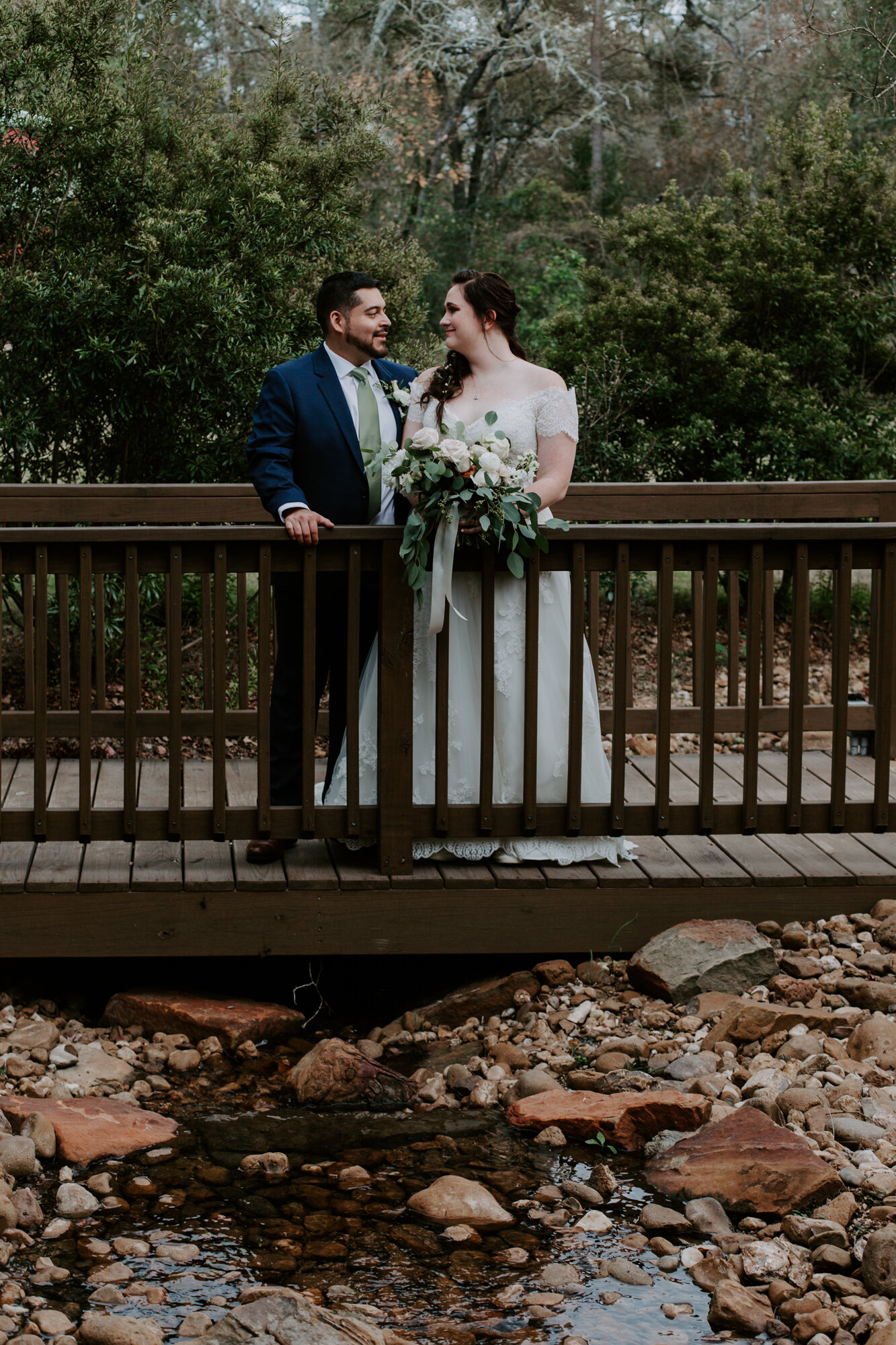 Bride and groom on the bridge. Fairy Romantic Wedding at Magnolia Bells in Magnolia, TX