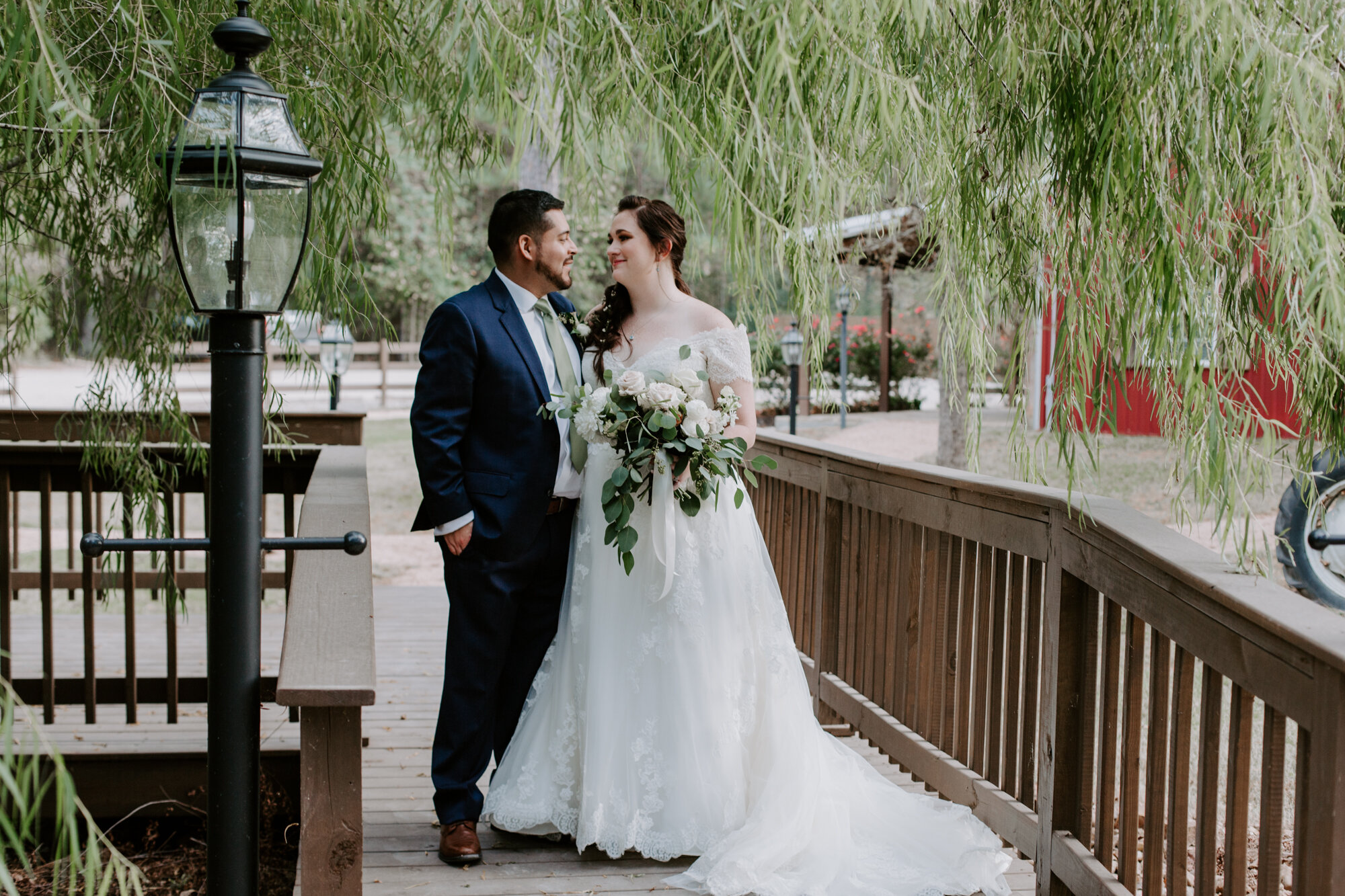 Bride and groom walking on a bridge. Fairy Romantic Wedding at Magnolia Bells in Magnolia, TX