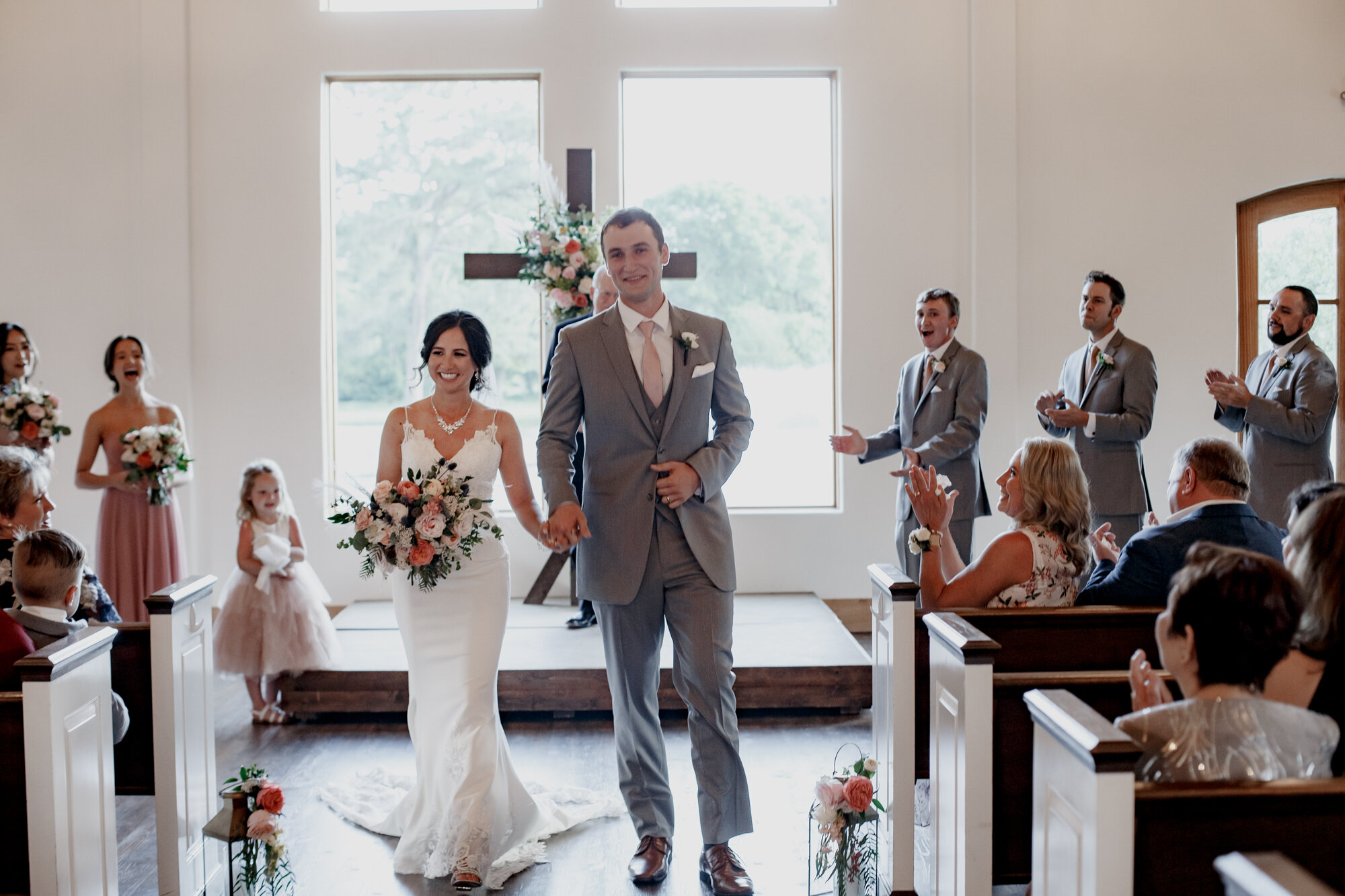 Bride and groom walking down the aisle. Romantic Chic Country Wedding at Rustic Luxury Balmorhea Events&nbsp;Venue in Magnolia, TX