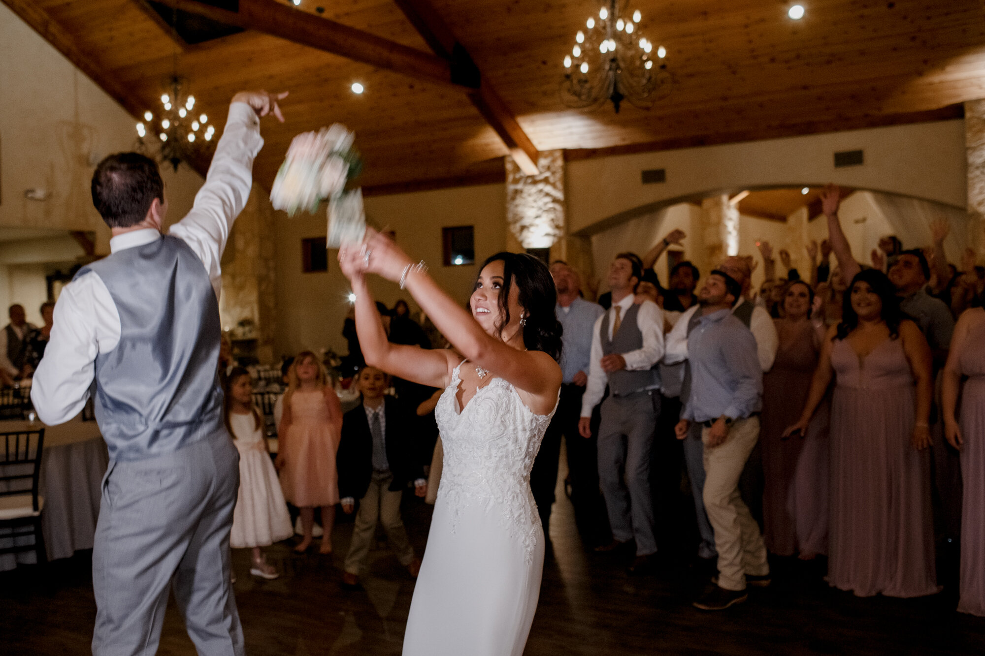 Bouquet toss. Romantic Chic Country Wedding at Rustic Luxury Balmorhea Events&nbsp;Venue in Magnolia, TX