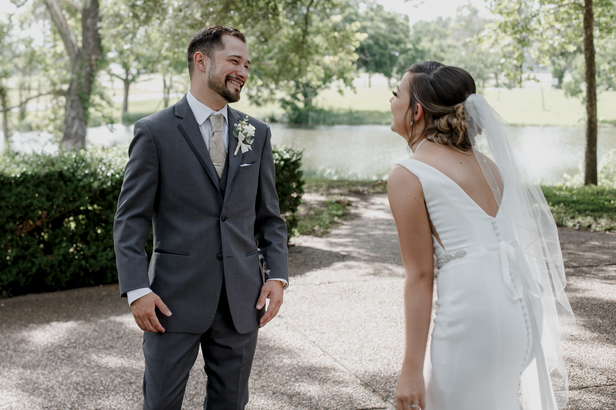 Bride and groom first look. Glowing Wedding in Golden Champagne Tones at The Orchard at Caney Creek in Wharton, TX