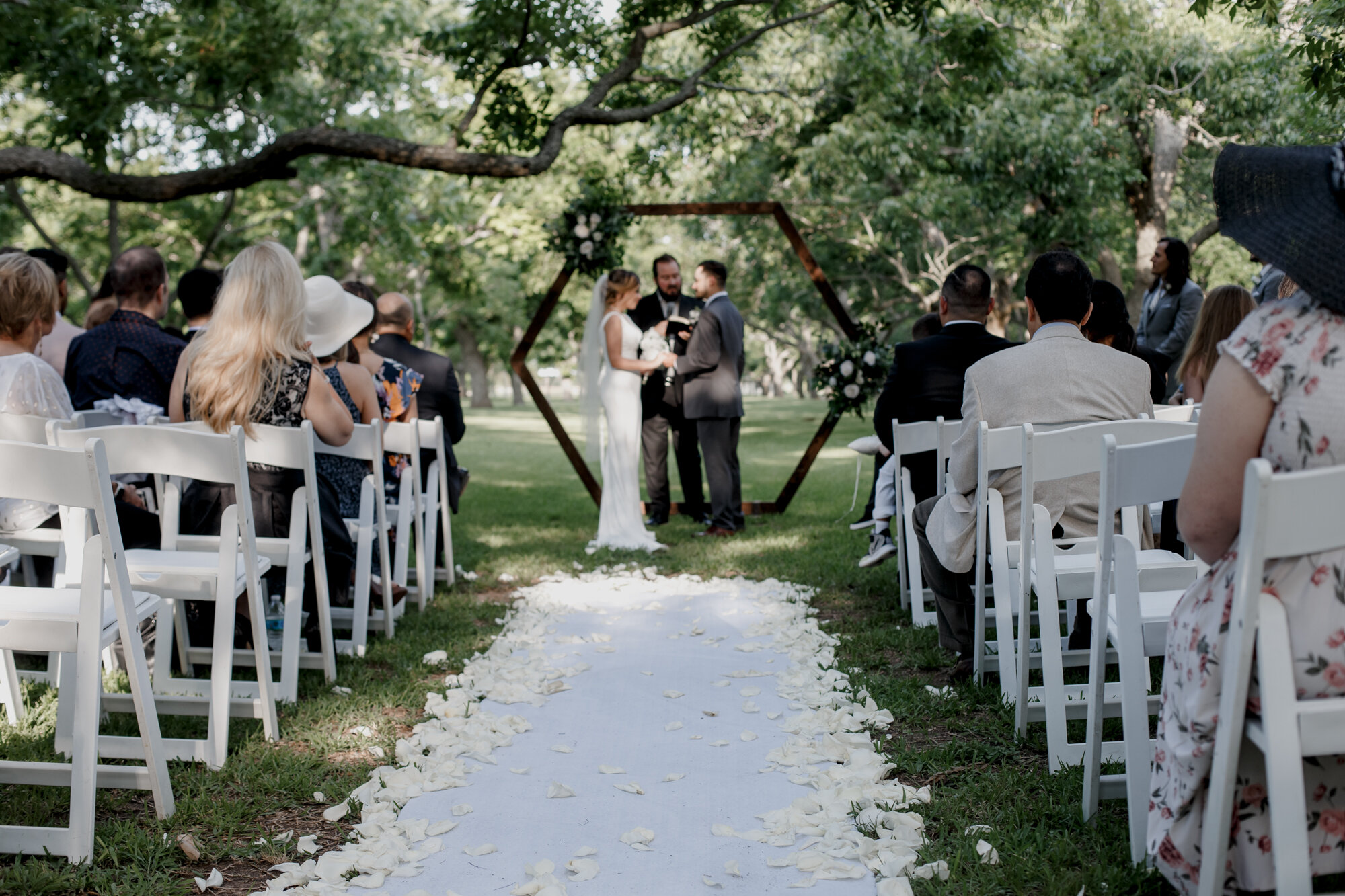 Glowing Wedding Ceremony in Golden Champagne Tones at The Orchard at Caney Creek in Wharton, TX