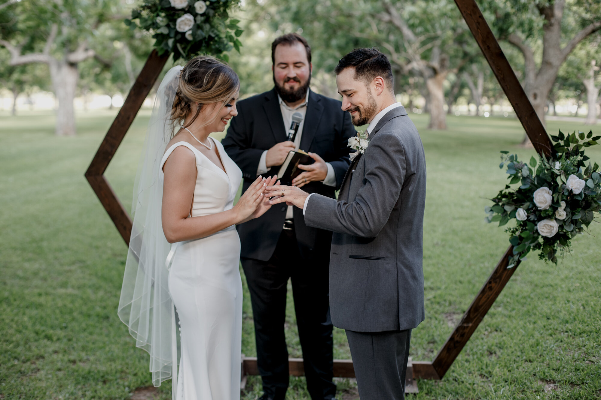 Bride and groom rings exchange. Glowing Wedding in Golden Champagne Tones at The Orchard at Caney Creek in Wharton, TX
