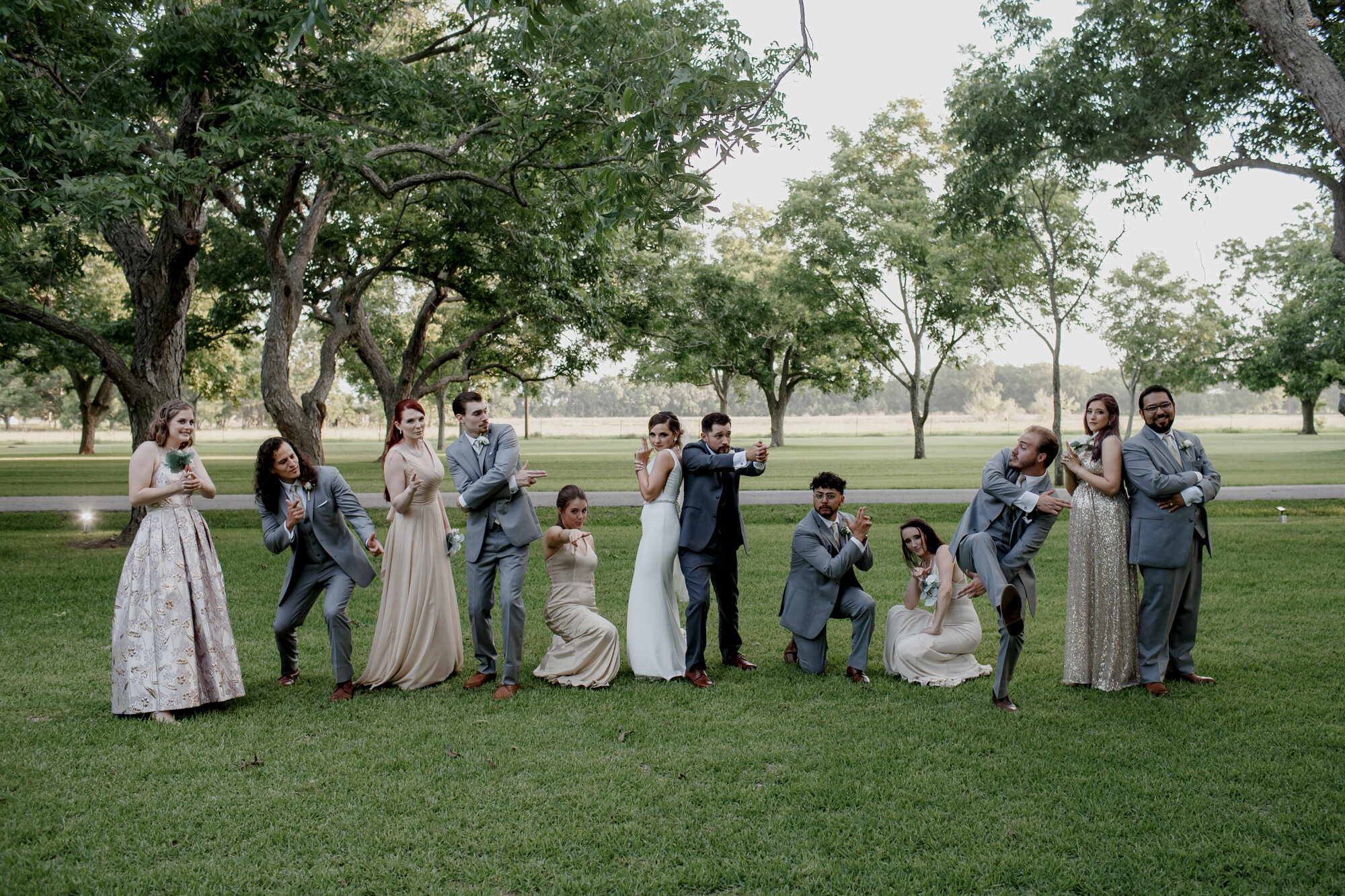 Bride and groom Charlie's Angels portraits with bridal party. Glowing Wedding in Golden Champagne Tones at The Orchard at Caney Creek in Wharton, TX