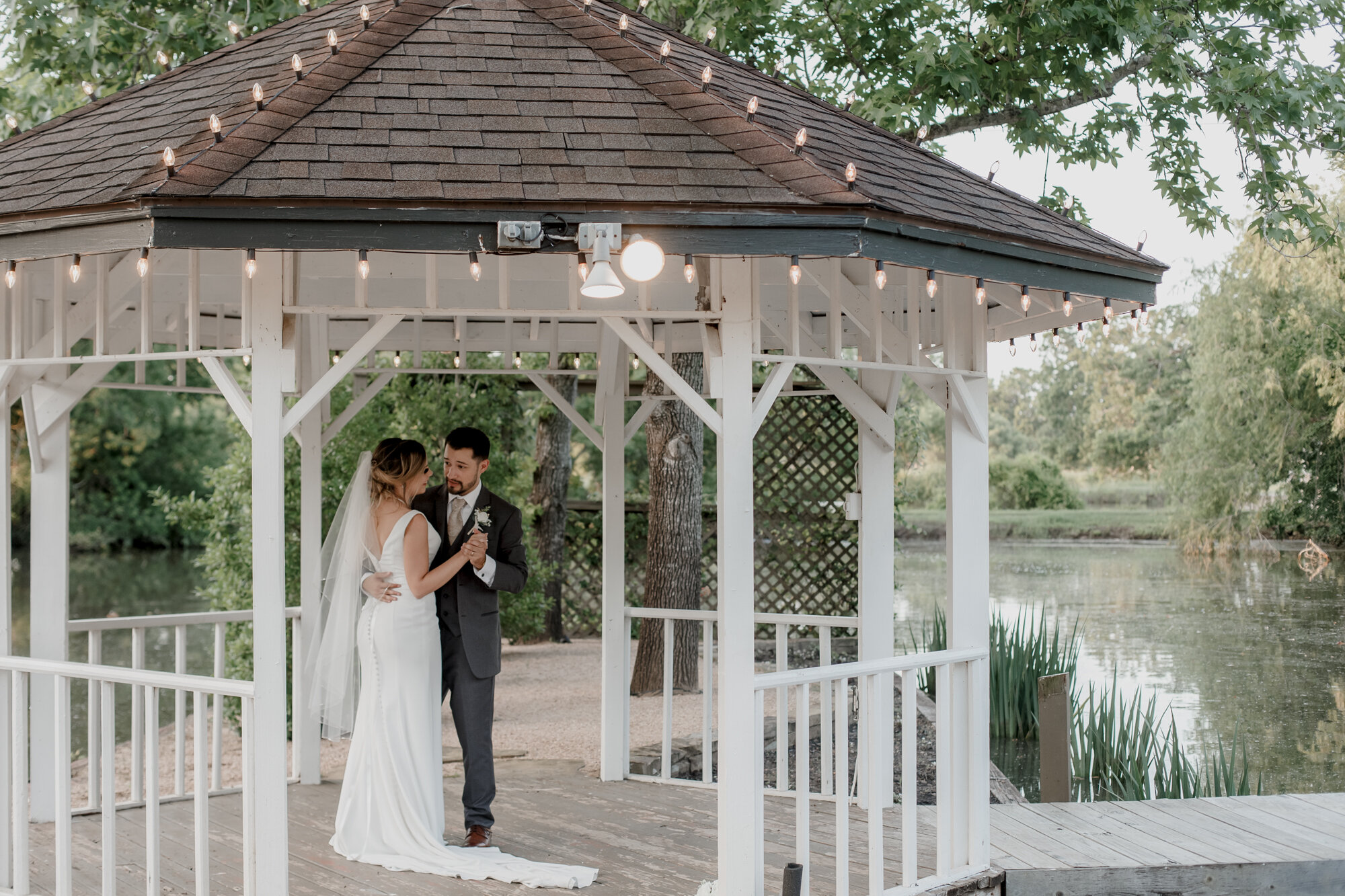 Bride and groom first dance in the gazebo. Glowing Wedding in Golden Champagne Tones at The Orchard at Caney Creek in Wharton, TX