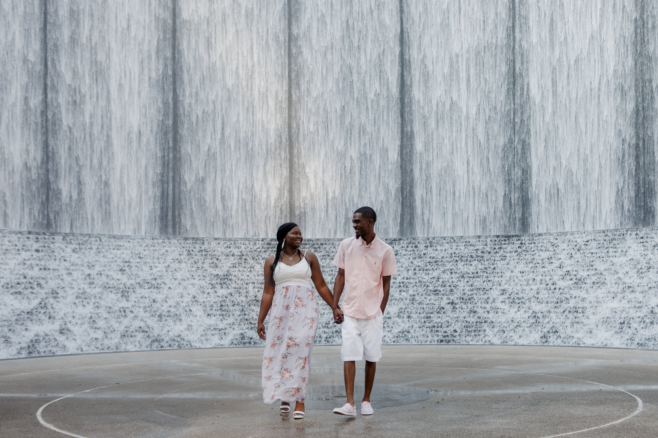 Couple walking holding hands. Early Morning Engagement Photo Session at Waterwall Place