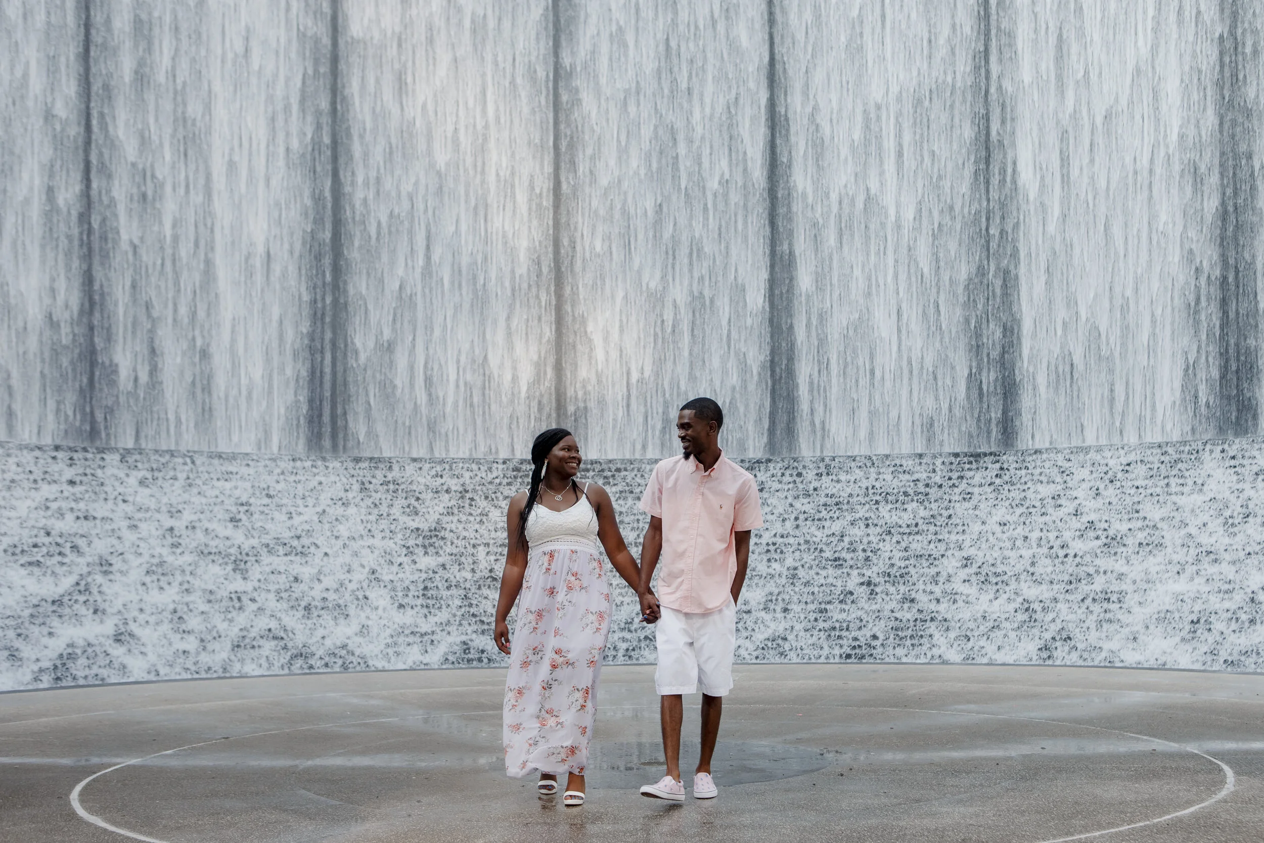 Couple walking holding hands. Early Morning Engagement Photo Session at Waterwall Park