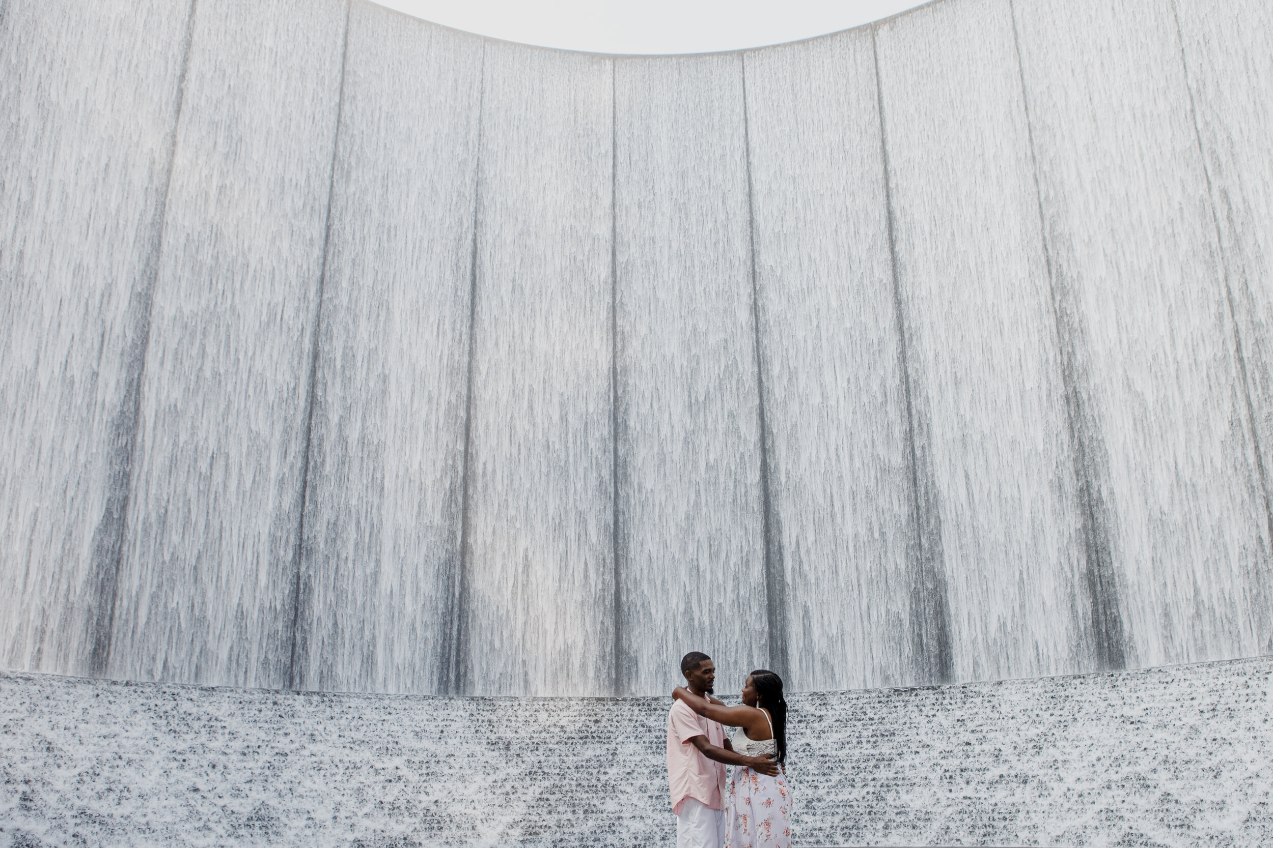Epic shot of a couple by the waterfall. Early Morning Engagement Photo Session at Waterwall Place
