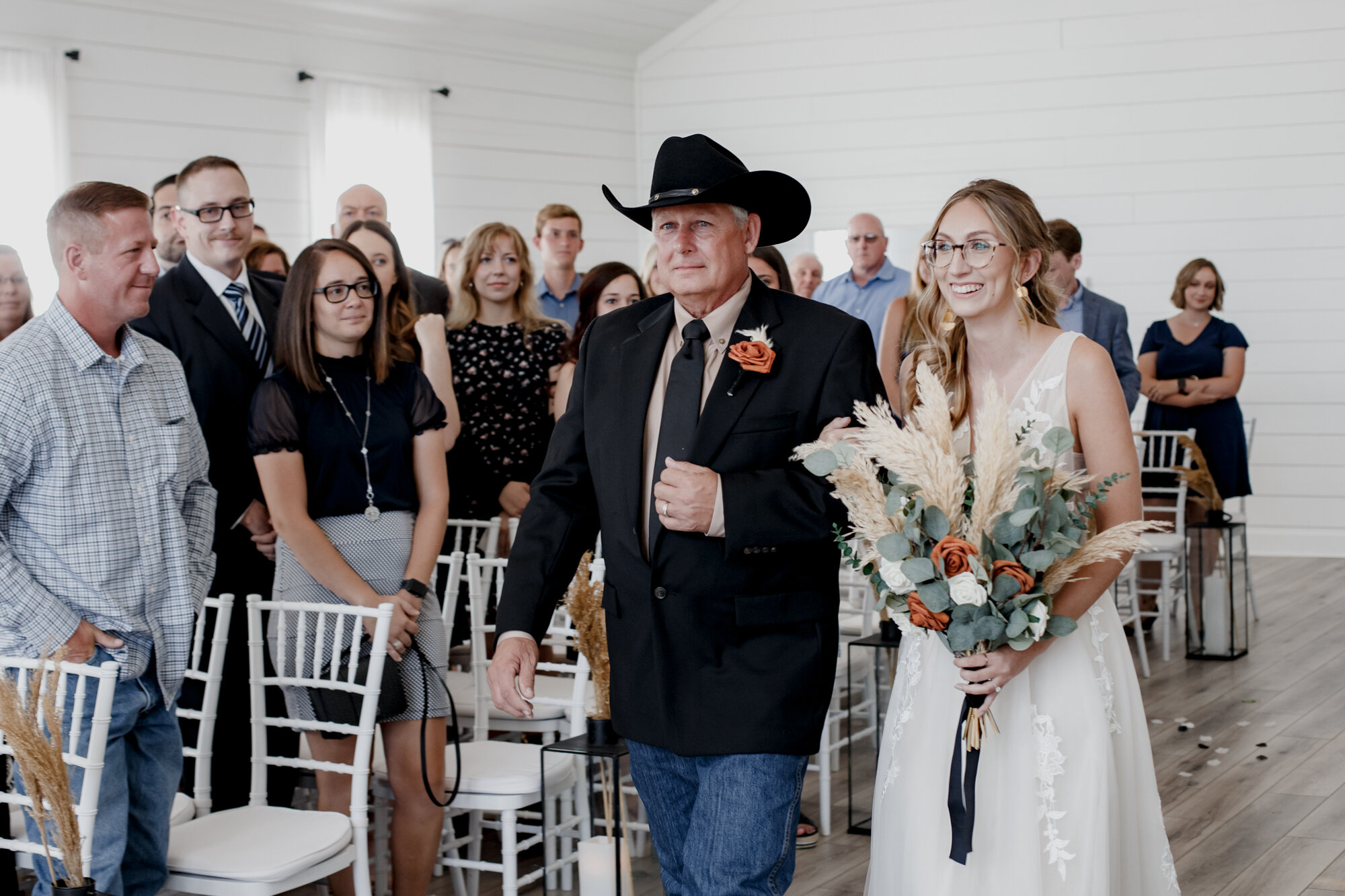 Father walking bride down the aisle. Burnt Orange and Black Fall Wedding at The Farmhouse