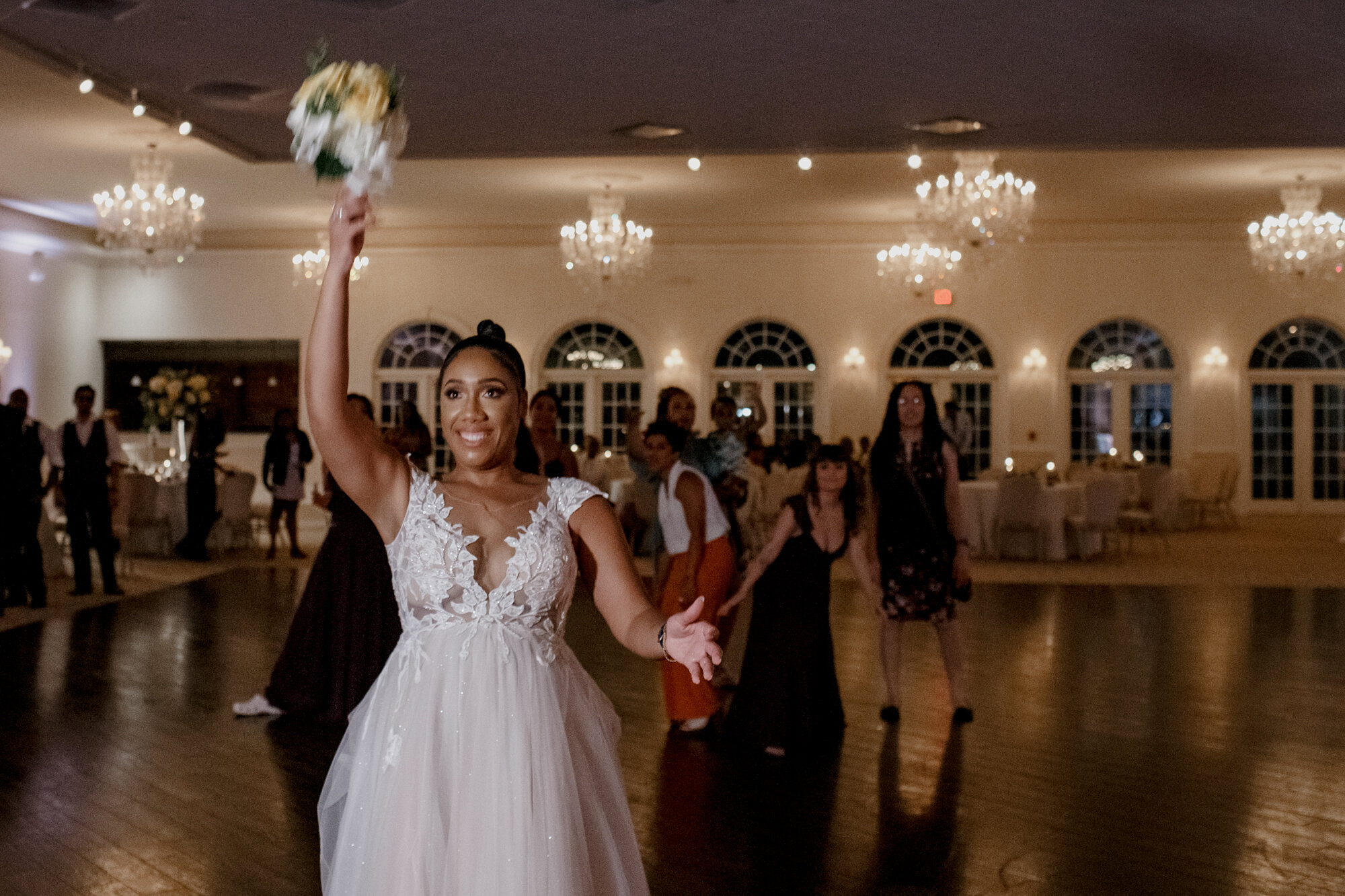 Bouquet toss. Elegant and Dazzling Wedding in Yellow and Purple at Ashton Gardens WestWedding at Ashton Gardens West (Houston, TX)