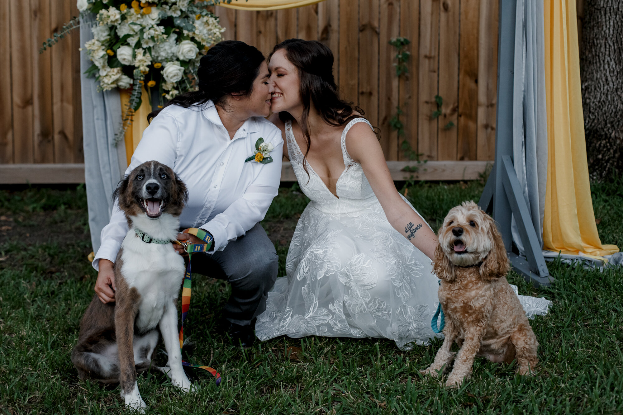 Cozy Laid-Back LGBTQ+ Backyard Wedding. Brides kiss portraits with dogs.