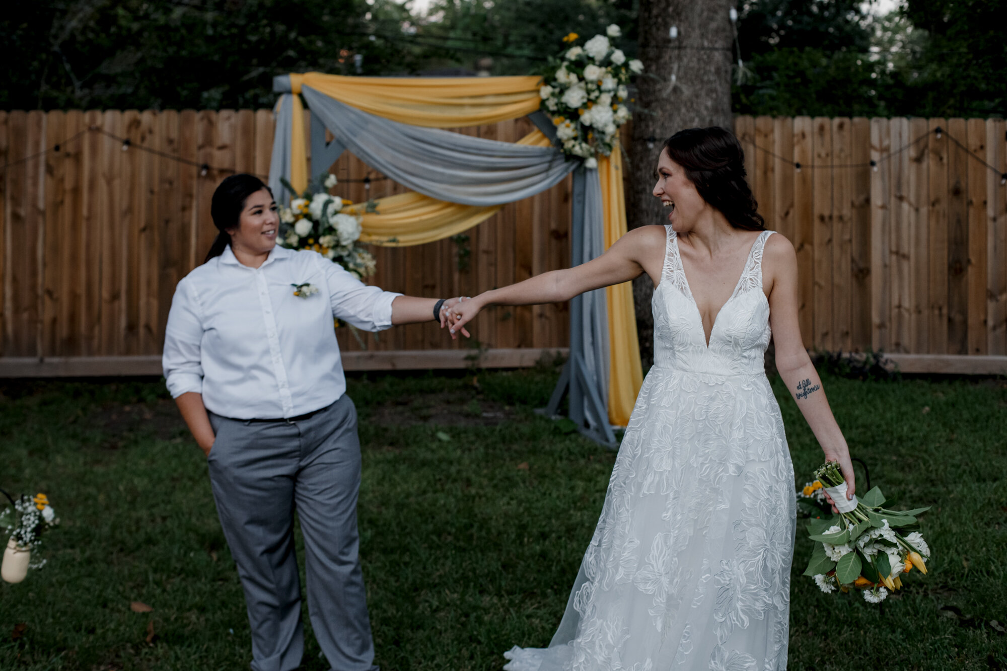 Cozy Laid-Back LGBTQ+ Backyard Wedding. Brides dance on the aisle.